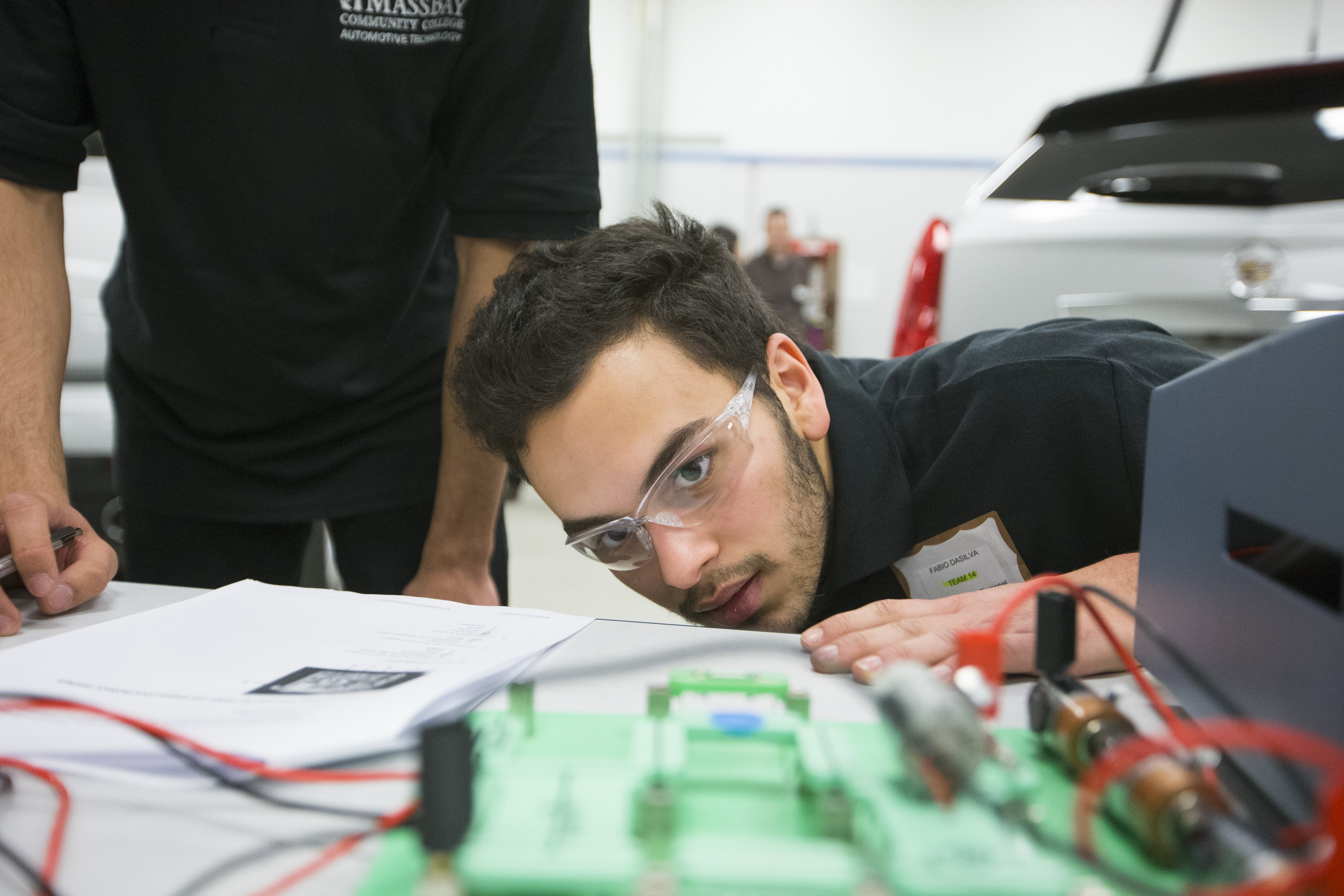 Fabio DaSilva, a junior at Assabet Valley Regional Technical High School, looks at an electrical board during the Massachusetts State Automobile Dealers Association competition at MassBay Community College in Ashland.