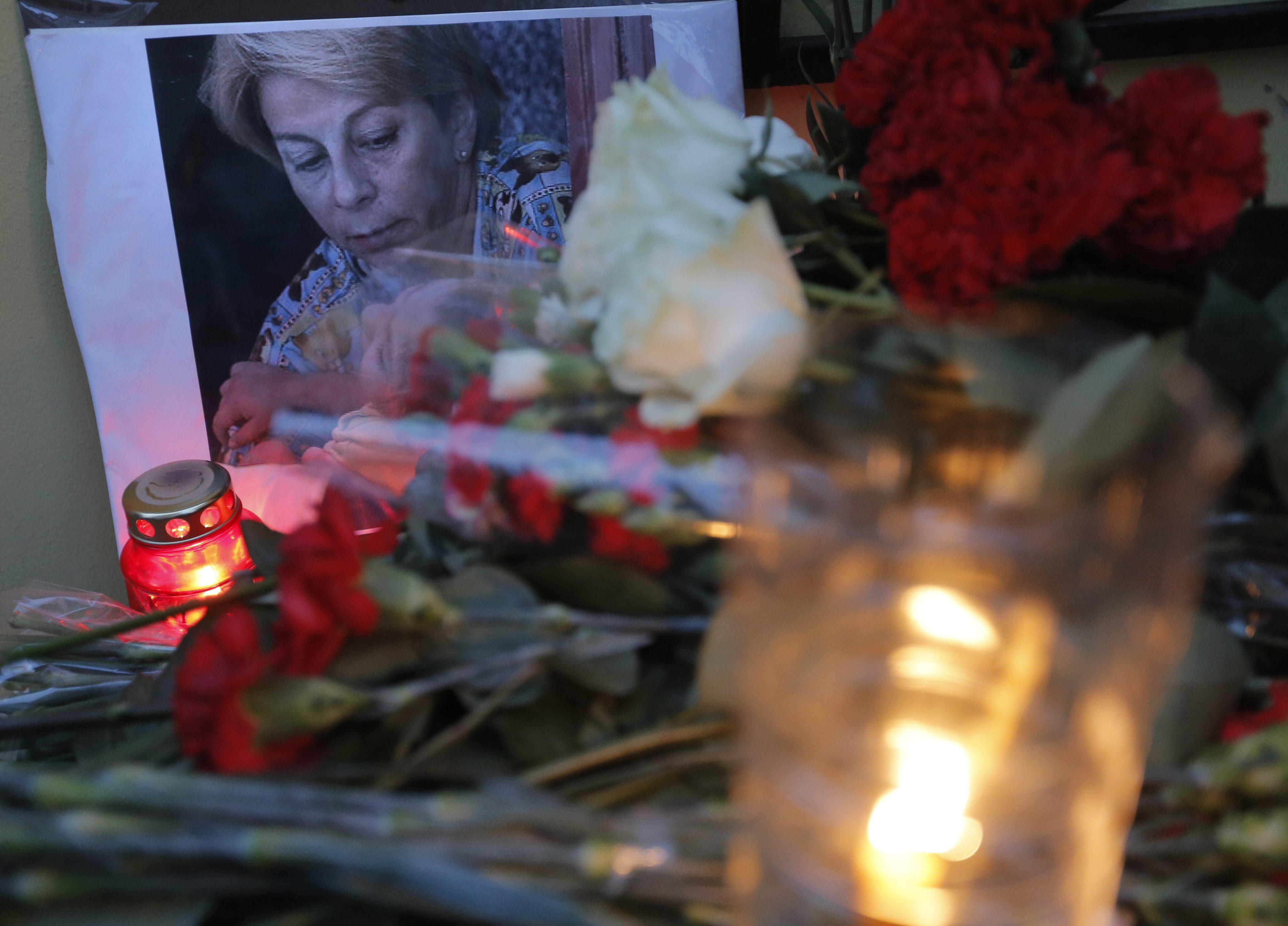 Flowers, candles, and a portrait of Yelizaveta Glinka were placed near an office of her charity group in Moscow.