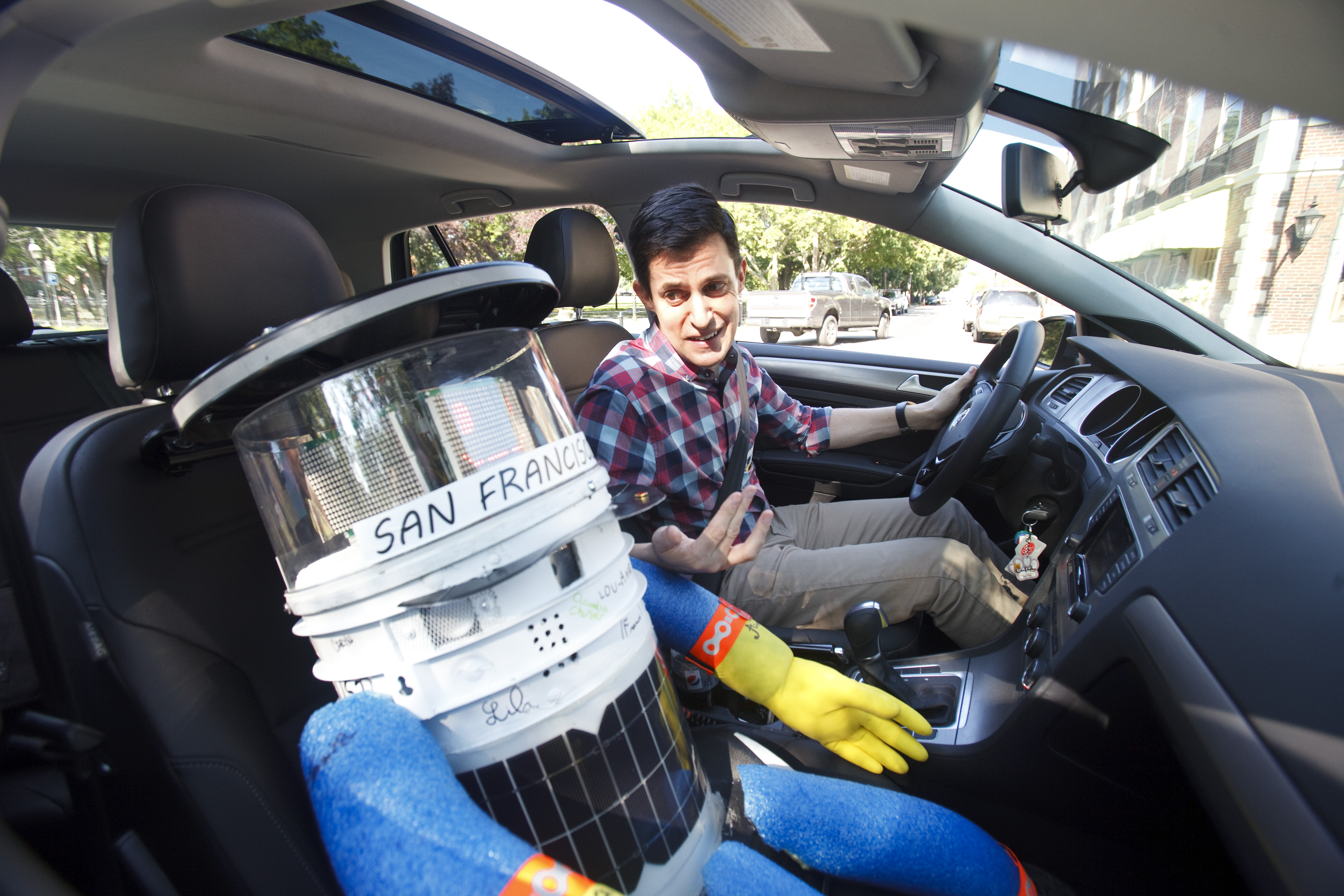 The author gives hitchBOT a ride around the block.