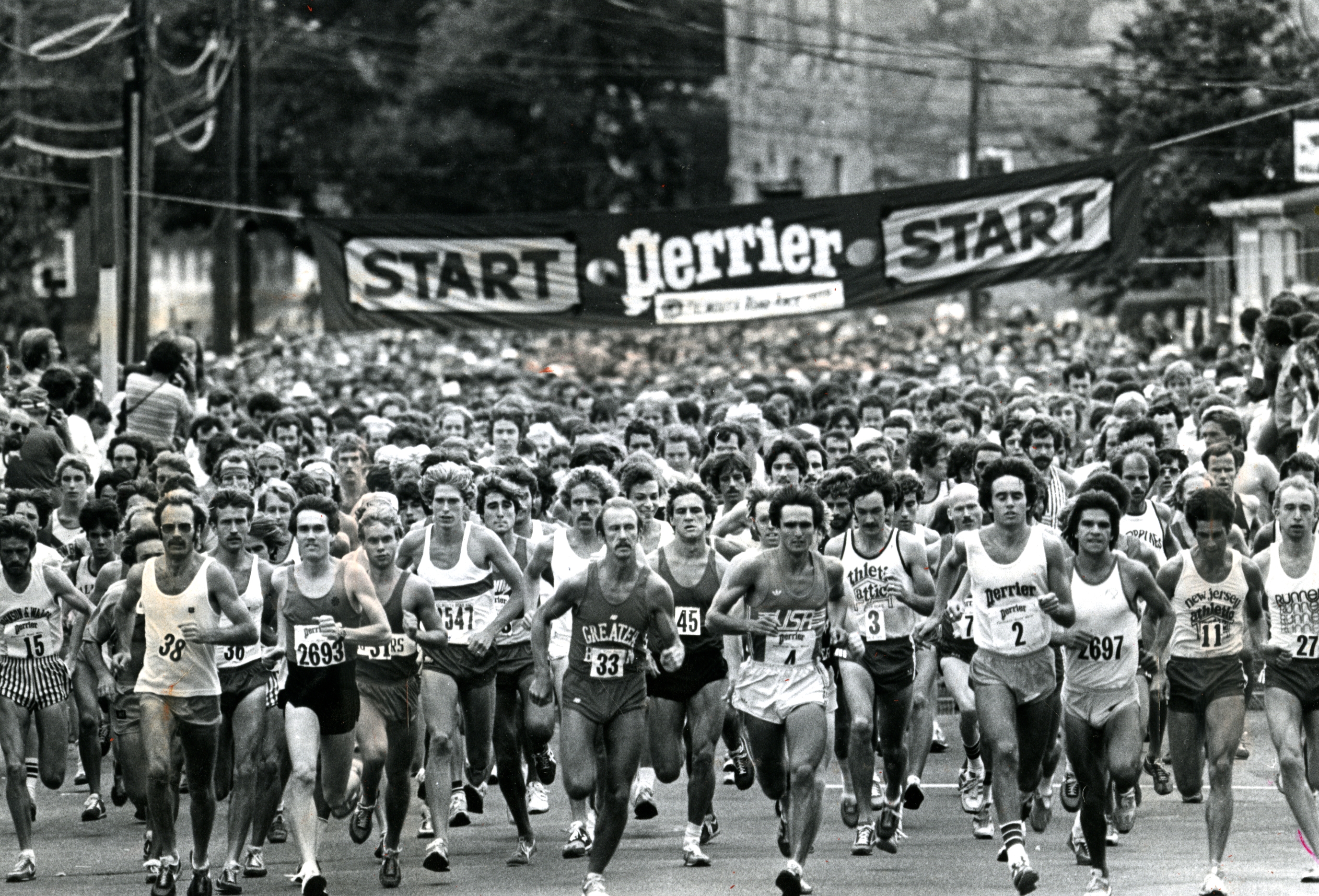 Thousands line the race course to see almost 13,000 entrants running the 7.1 miles through the streets of Falmouth.
