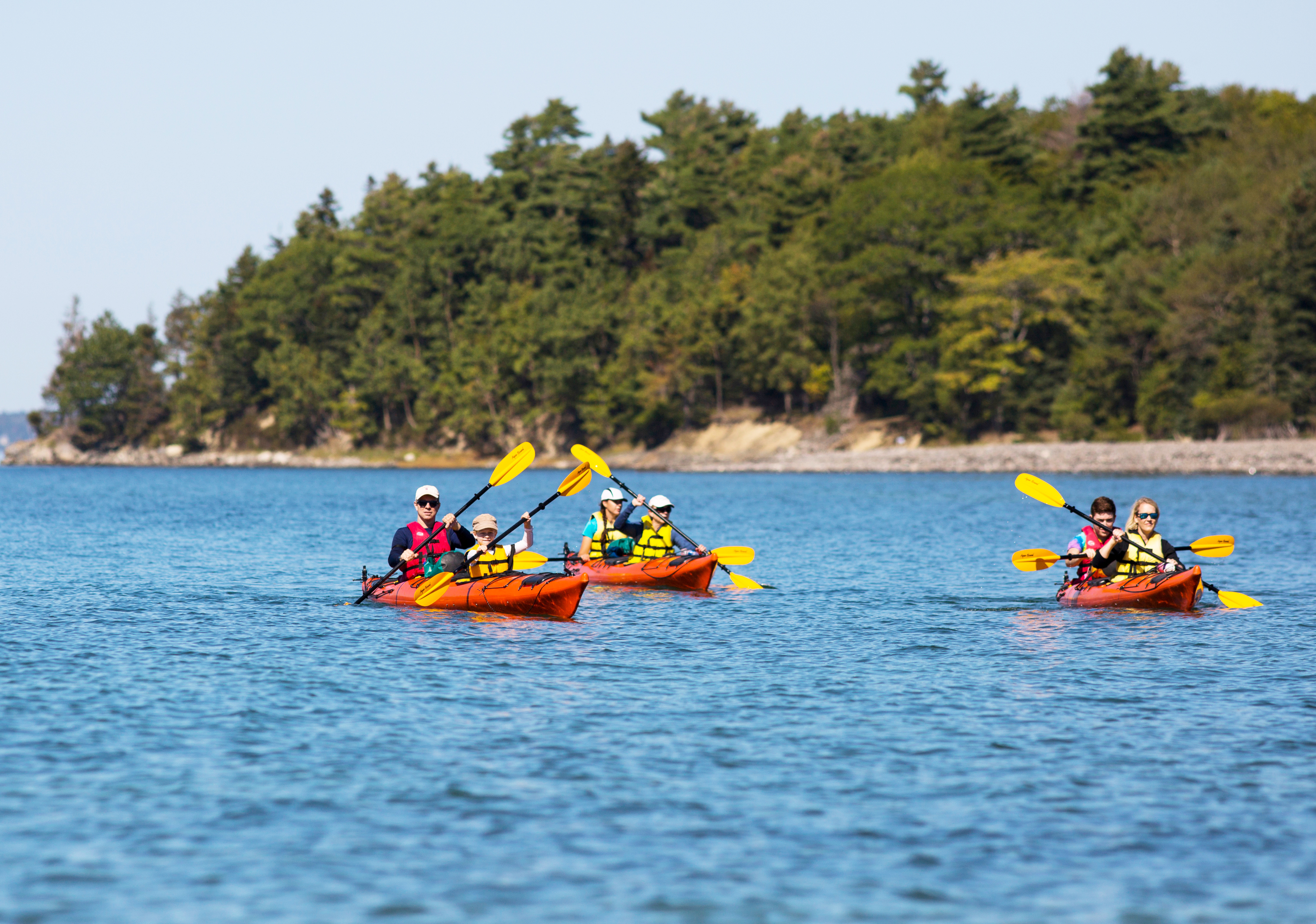 Get on the water. Here, kayakers paddle the sheltered bays and scenic coves along Maine's coastline.