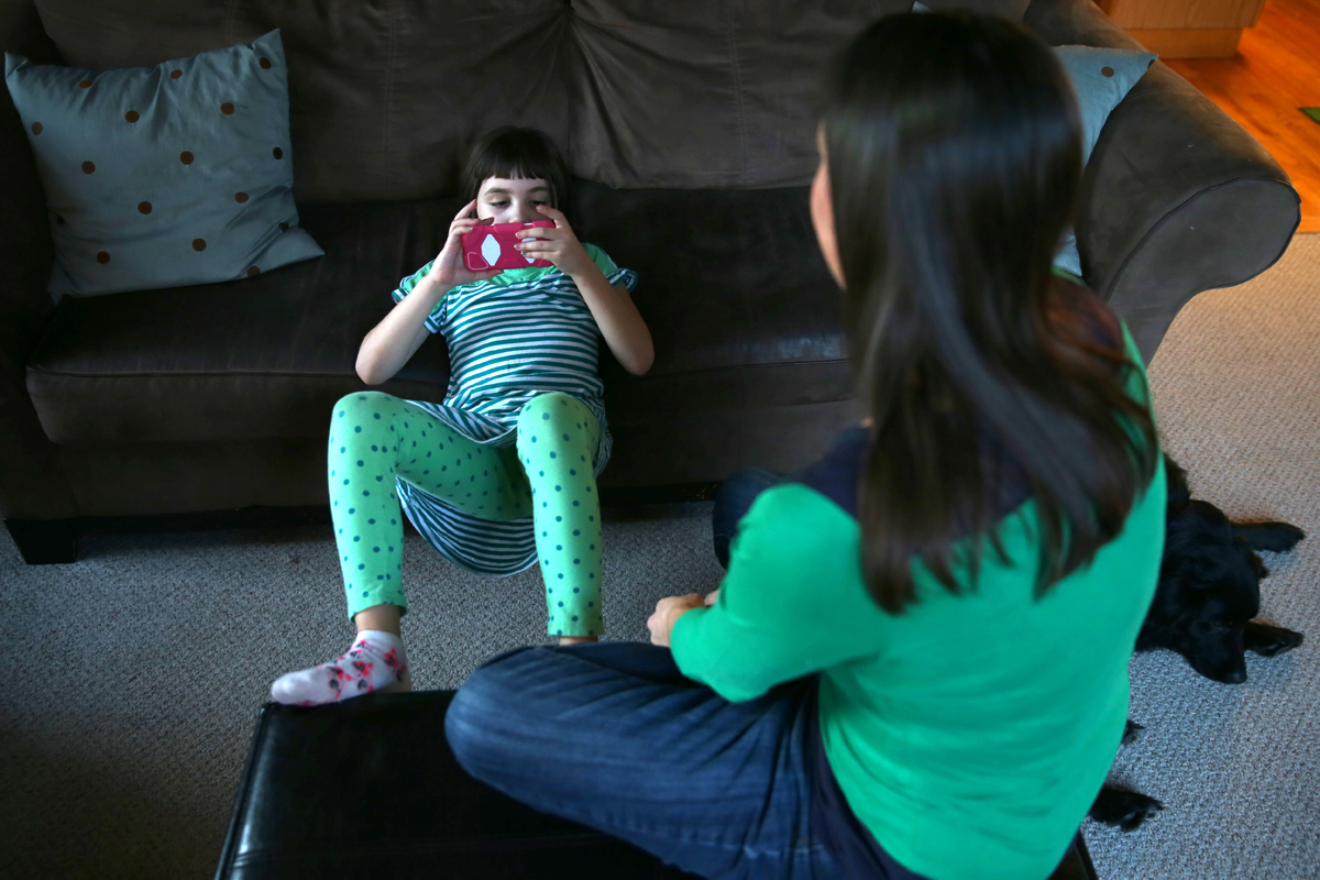 Haley Osborn, 7, who has severe epilepsy, with her service dog and her mother, Jill. A handful of studies suggest an ingredient in marijuana might cut frequency of seizures.