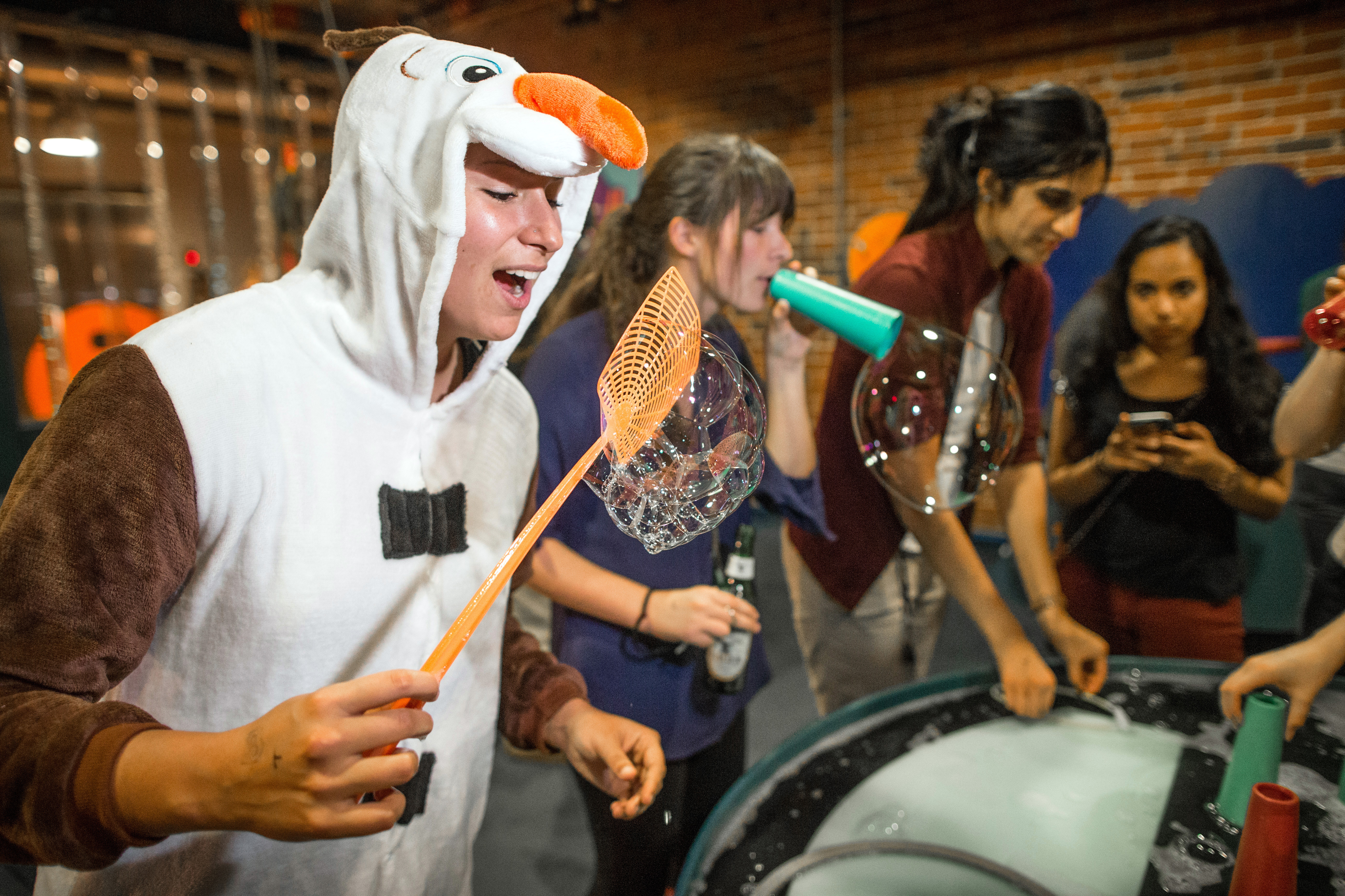 Isabelle Gell-Levey played with bubbles while dressed as Olaf during a Boston Grown-Ups Museum event held at the Boston Children's Museum.