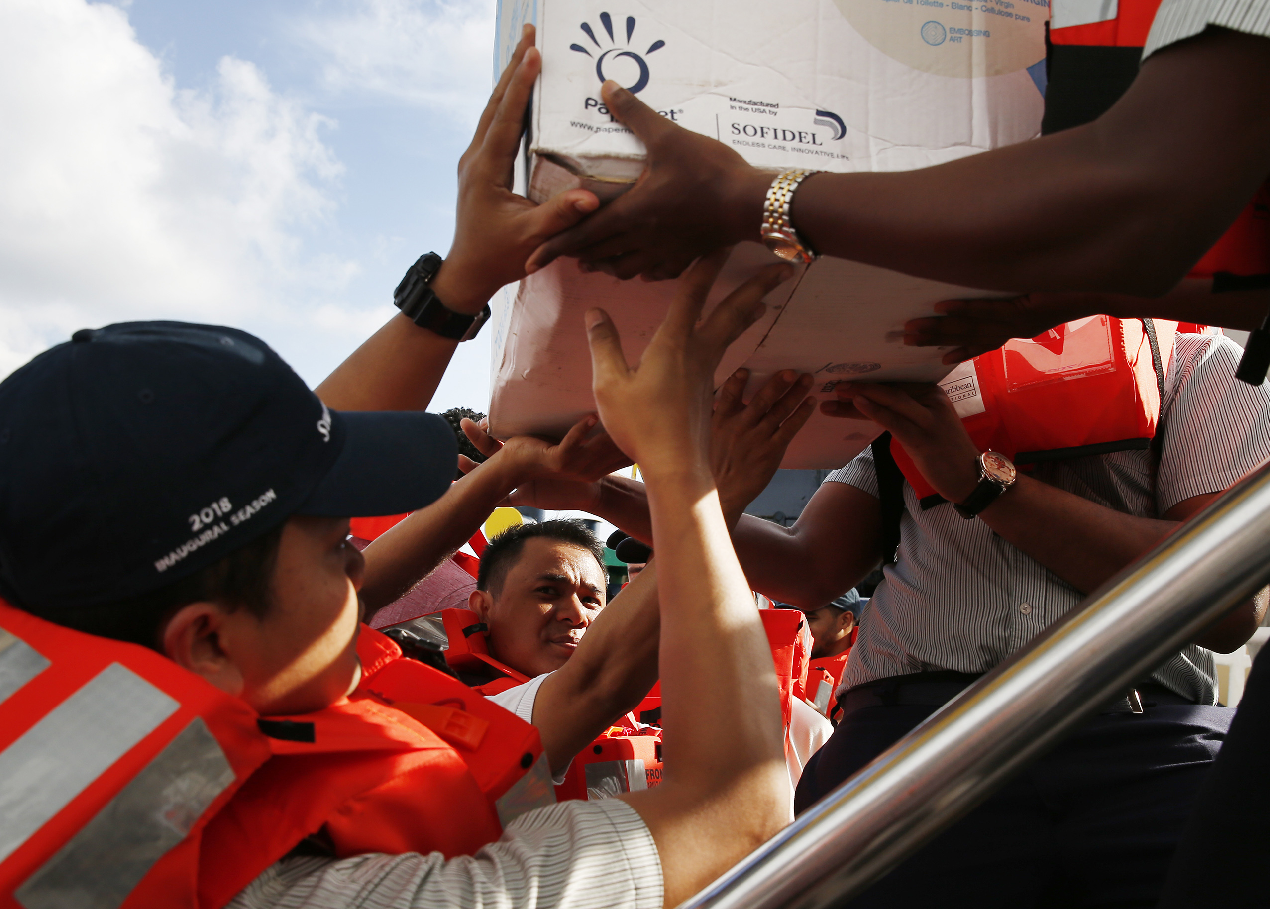 Royal Caribbean staff members loaded relief supplies onto a boat bound for Freeport, Bahamas, to bring to hurricane survivors.