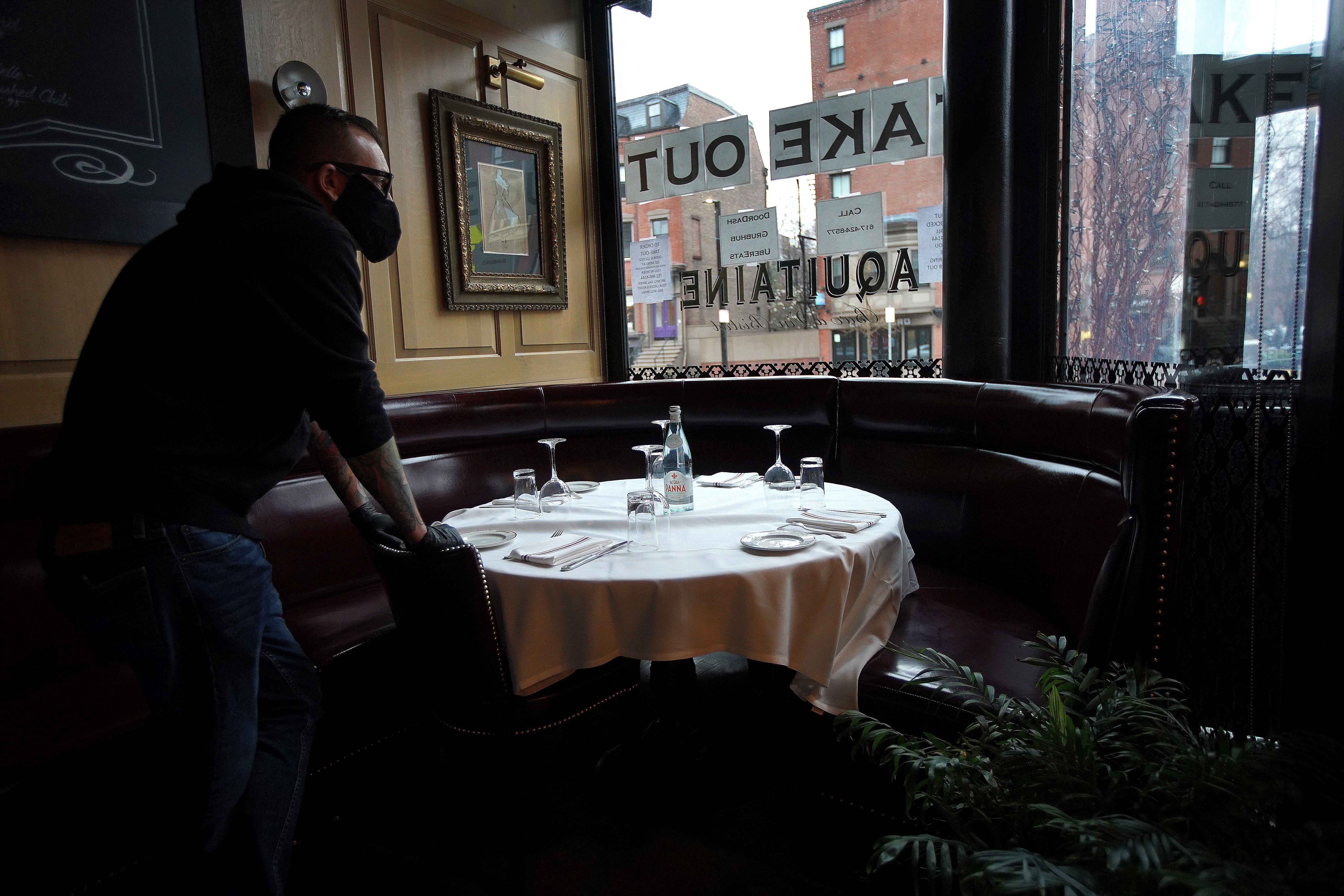 Aquitane Restaurant Group Manager Scott Lamb looked out his restaurant's window which now offers take-out only due to the coronavirus.