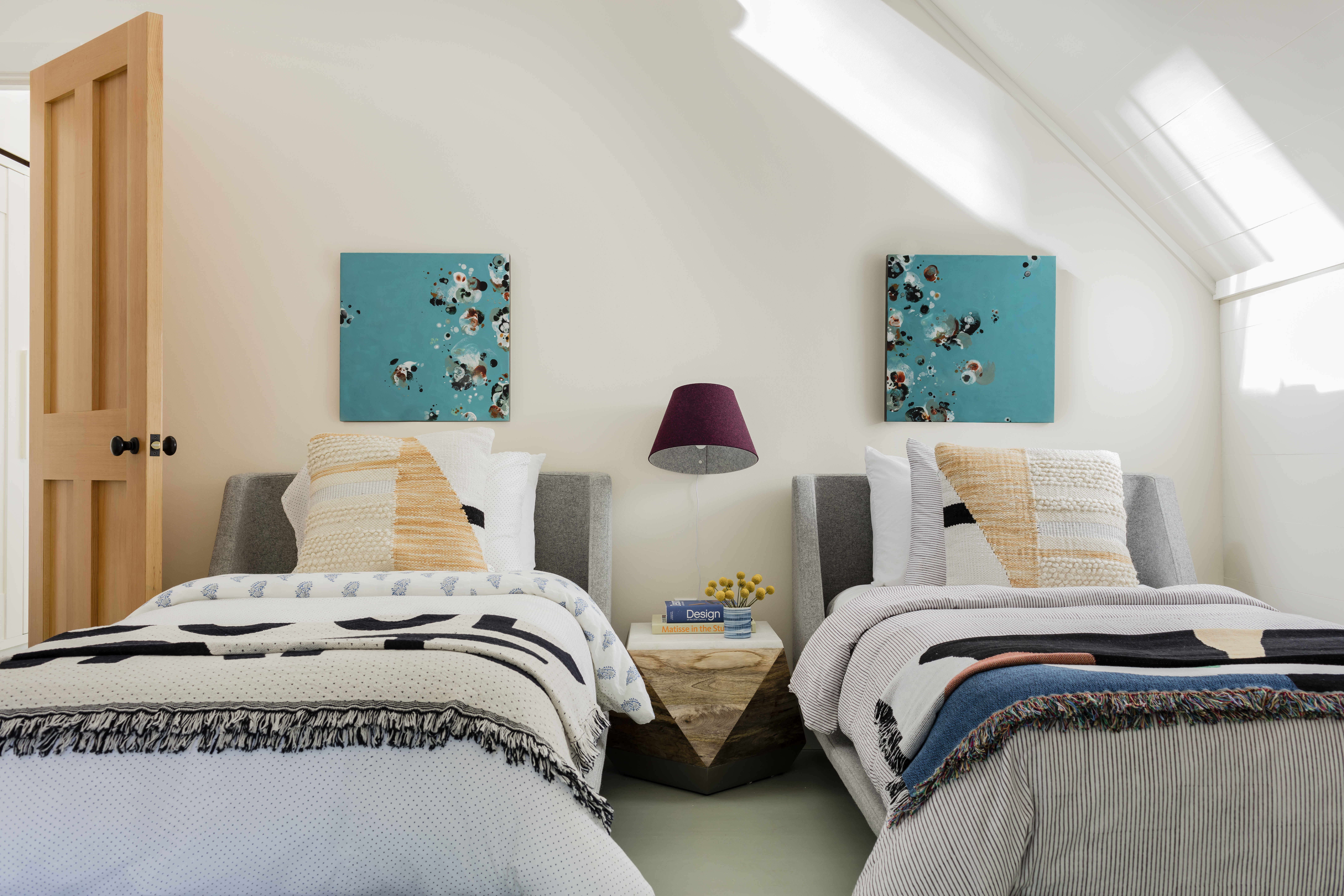 An encaustic diptych by Leslie Stoner, from Chase Young Gallery in Boston, hangs in the guest room.