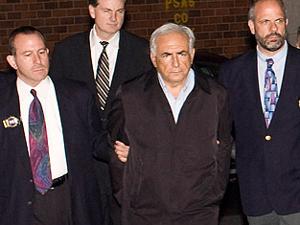 Dominique Strauss-Kahn is walked to a police vehicle outside a New York City Police Department facility on May 15, 2011