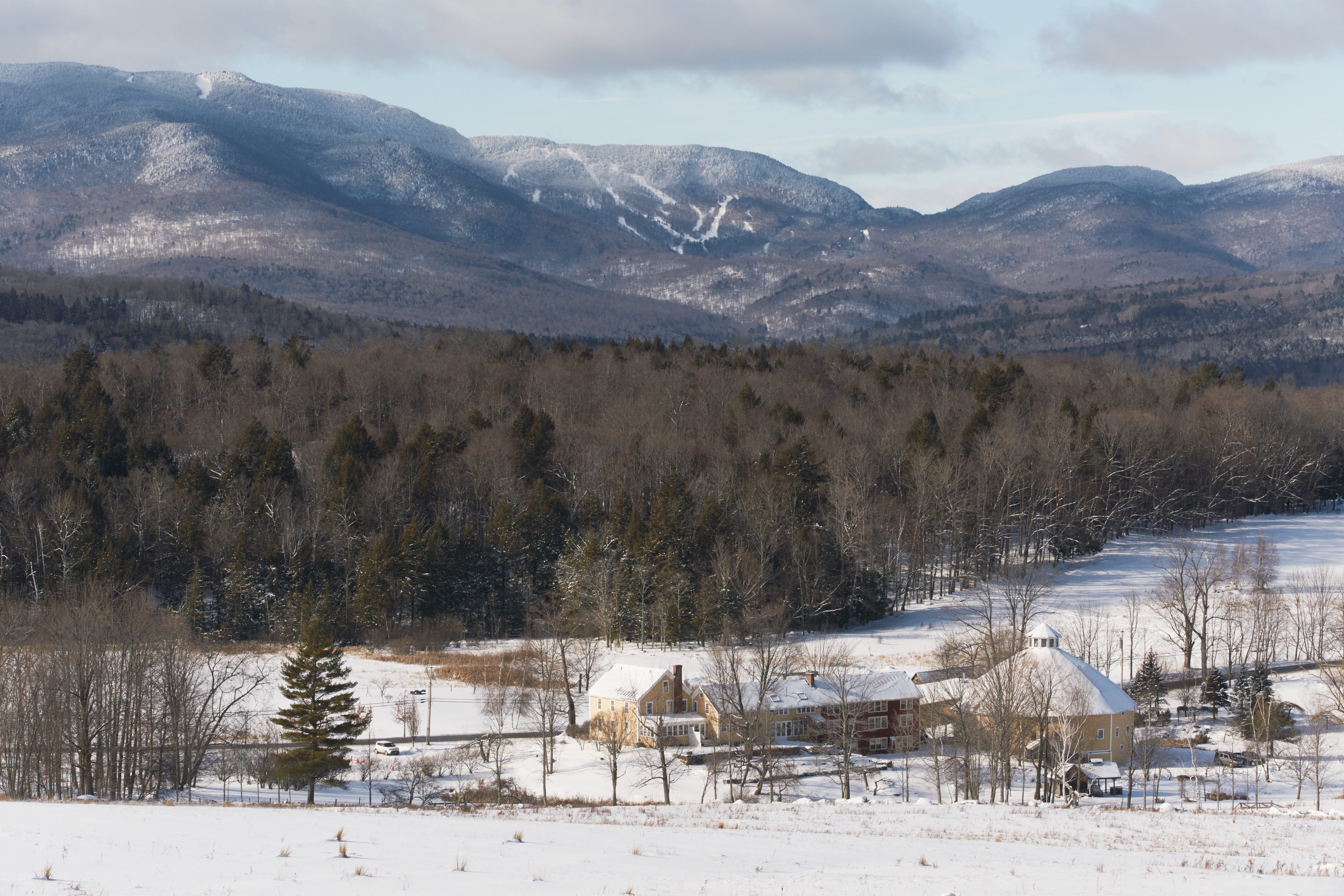 The Inn at The Round Barn Farm, with the Mad River Glen Ski Resort in the background.