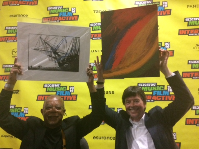 At South by Southwest, Harvard’s Henry Louis Gates Jr., left, and filmmaker Ken Burns, hoist work by artists helped by ArtLifting. Burns is holding a painting by Nick Morse.