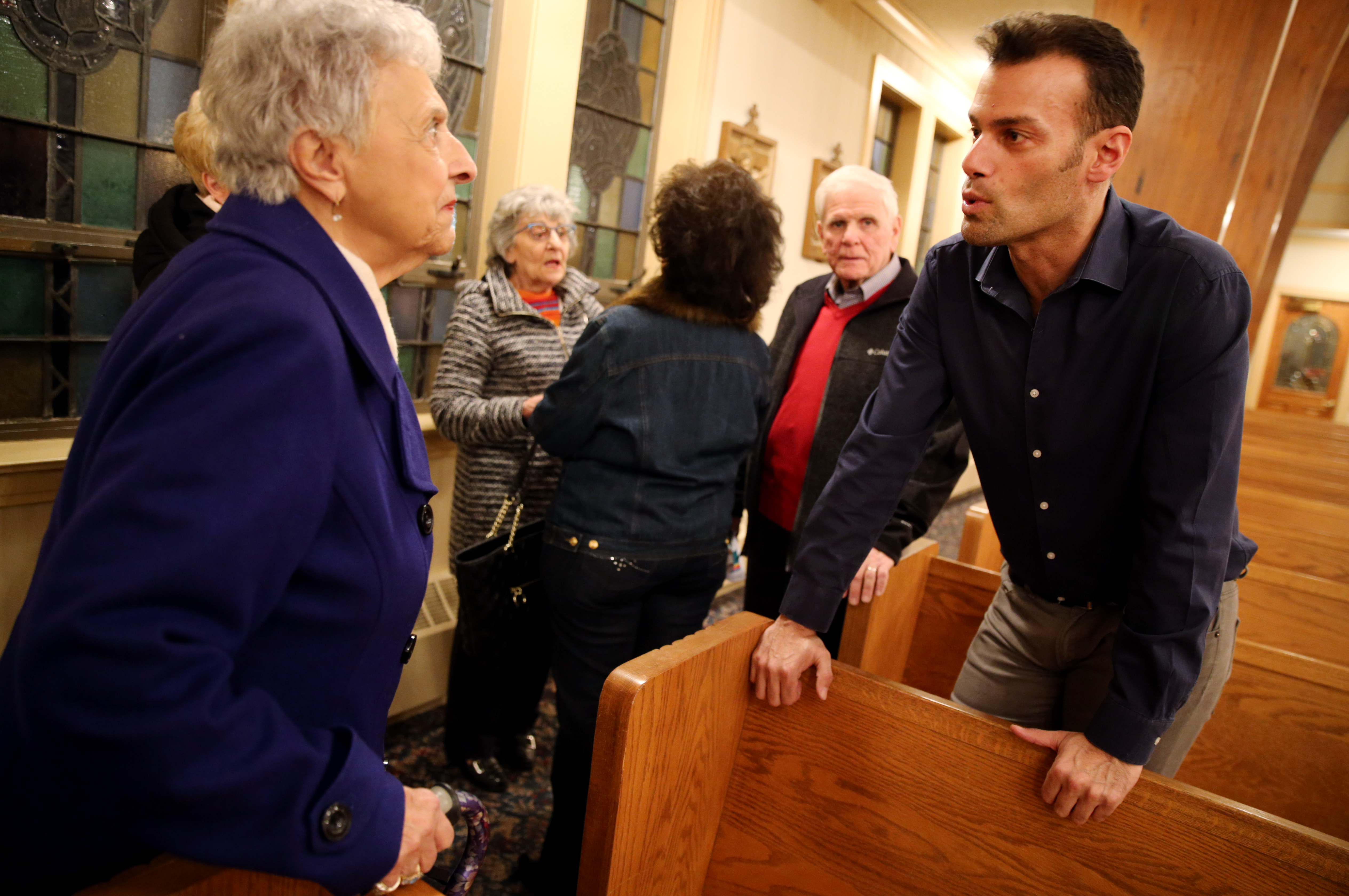 Andrew Giordano talks with Susan Stazzere following a church service at St. Barbara Parish Church in Woburn.