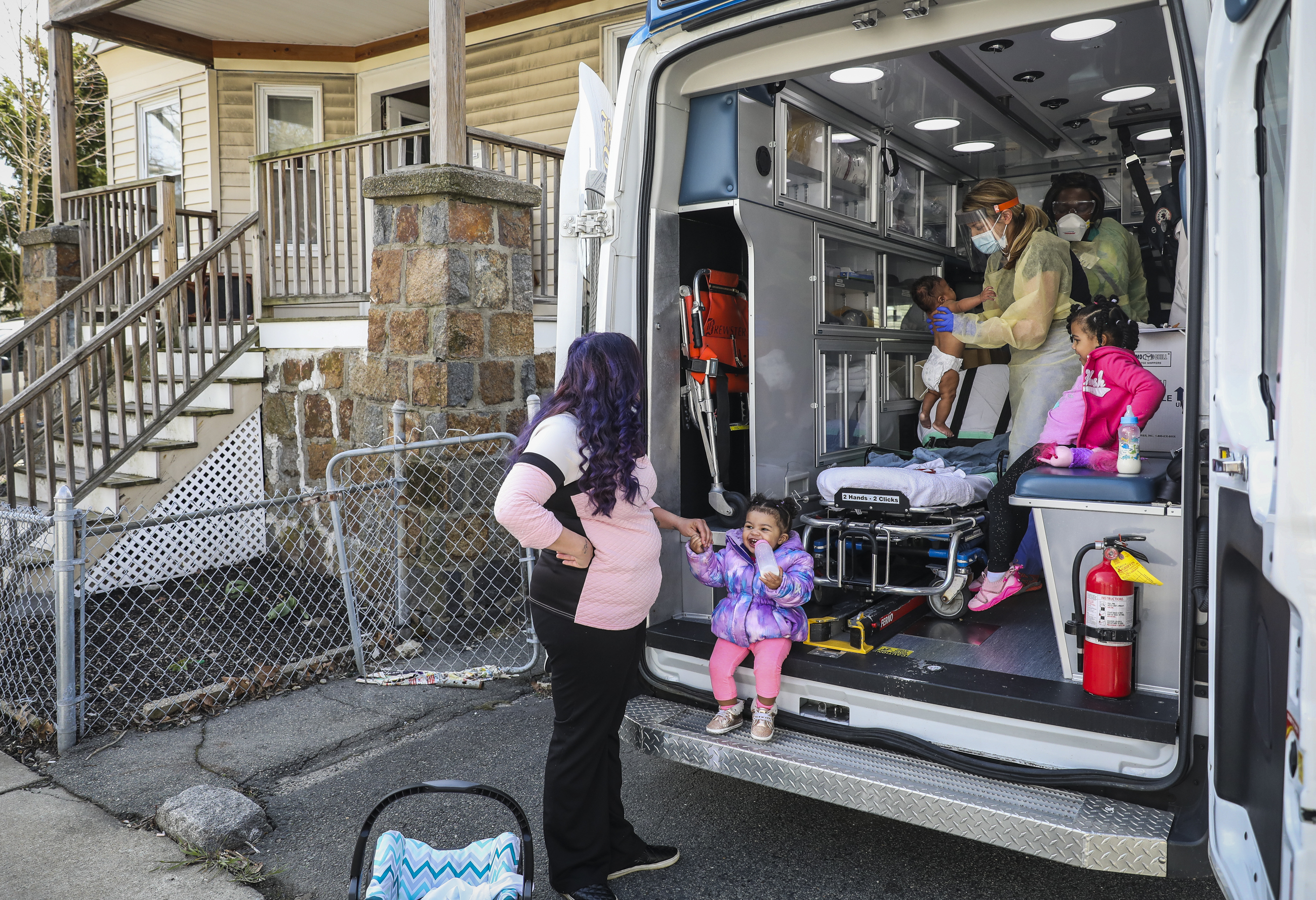 Rebecca Dittami stood with her children Loyalty Rucker, 16 months, Truth Rucker, 4-years-old, and Eddie Rucker, 4-months-old, as they were seen by their primary care physician, Dr. Rachel Sagor.