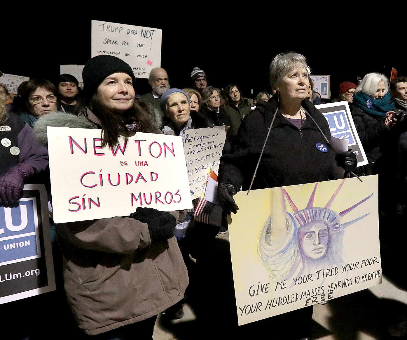 Ralliers called for Newton to become a "Welcoming City," outside Newton City Hall on Tuesday.