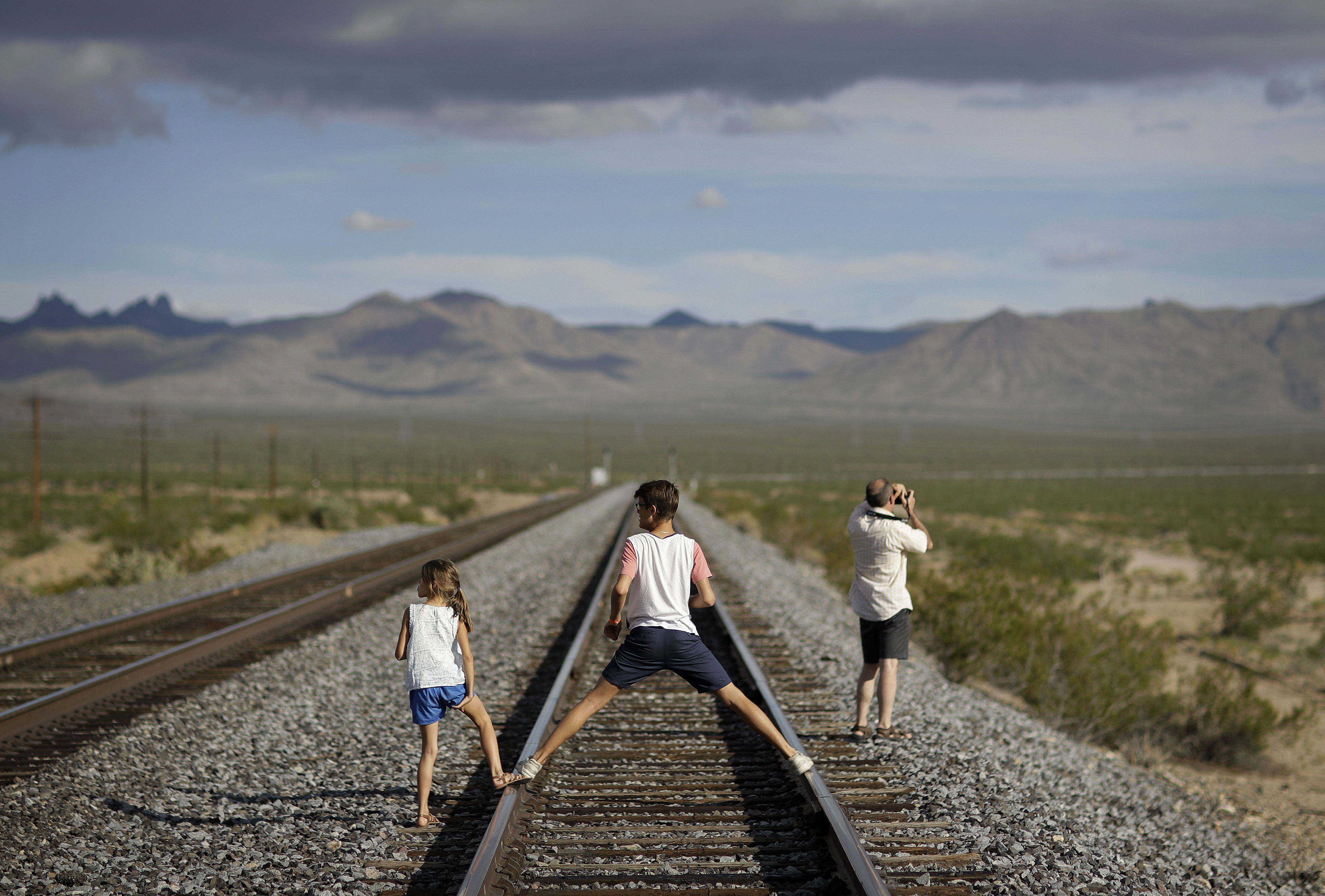 A family walked along train tracks.