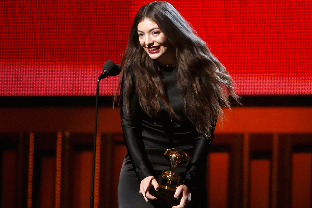 Lorde holds her trophy for best pop solo performance.