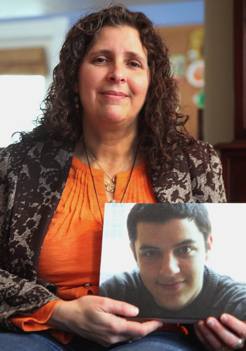 Cambridge resident Lise Stern holding a photo of her son Eitan Stern-Robbins, who died Unexpected Death in Epilepsy (SUDEP) on Valentine’s Day 2013.