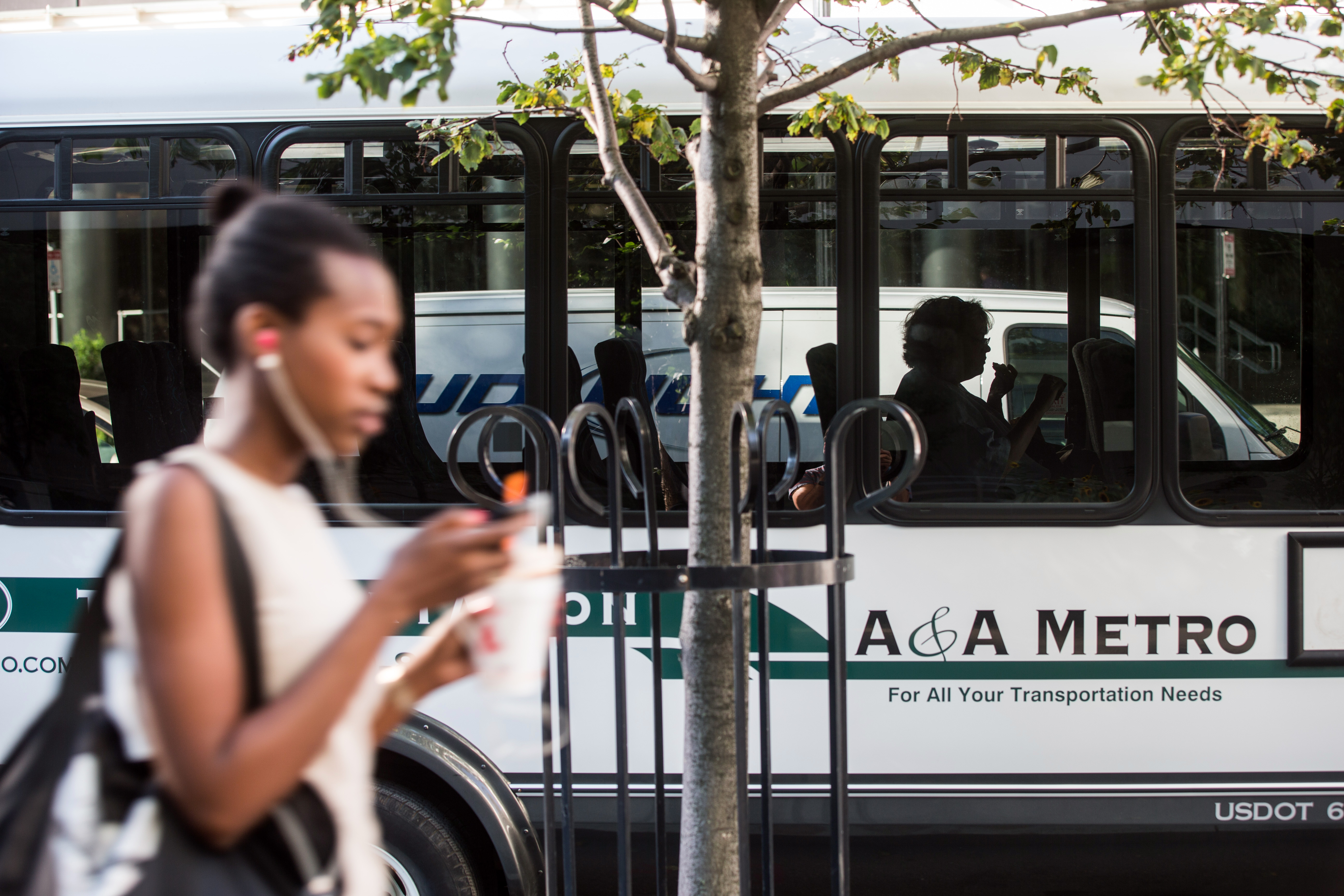 A single rider sat inside a private shuttle parked along Summer Street near the Federal Reserve building in Boston. Afar-reaching plan, funded by key waterfront firms, would consolidate 20 private shuttle routes into two bus routes to address traffic congestion in the area.