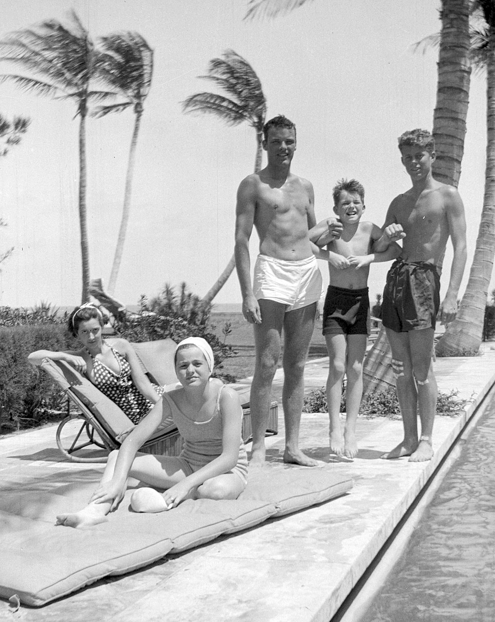 This October 1936 photo shows John F. Kennedy, right, Robert F. Kennedy, second from right, and Patricia Kennedy, front left, posing with friends in Palm Beach, Fla.