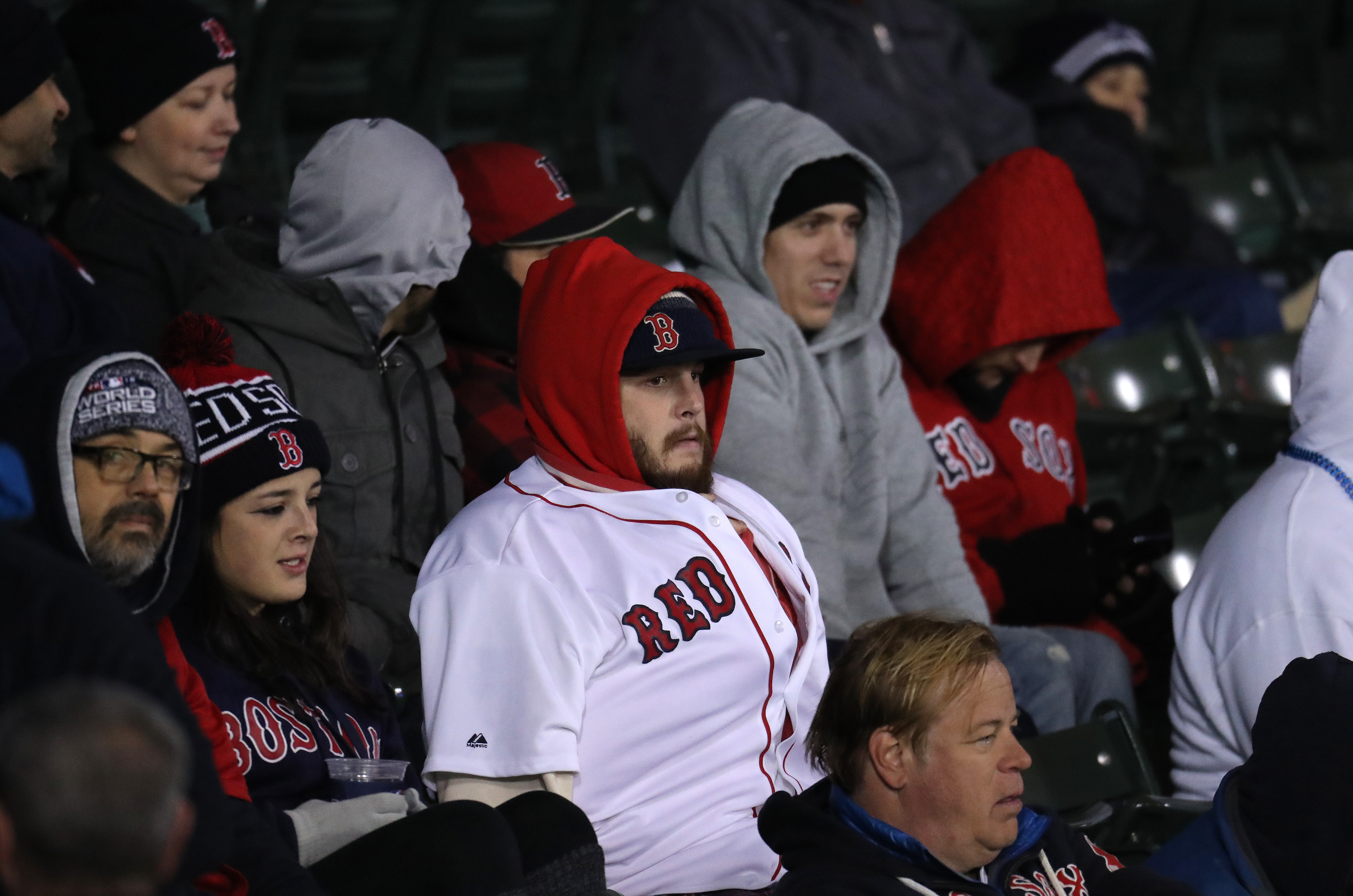 Fans in the stands at Fenway Park are bundled up.