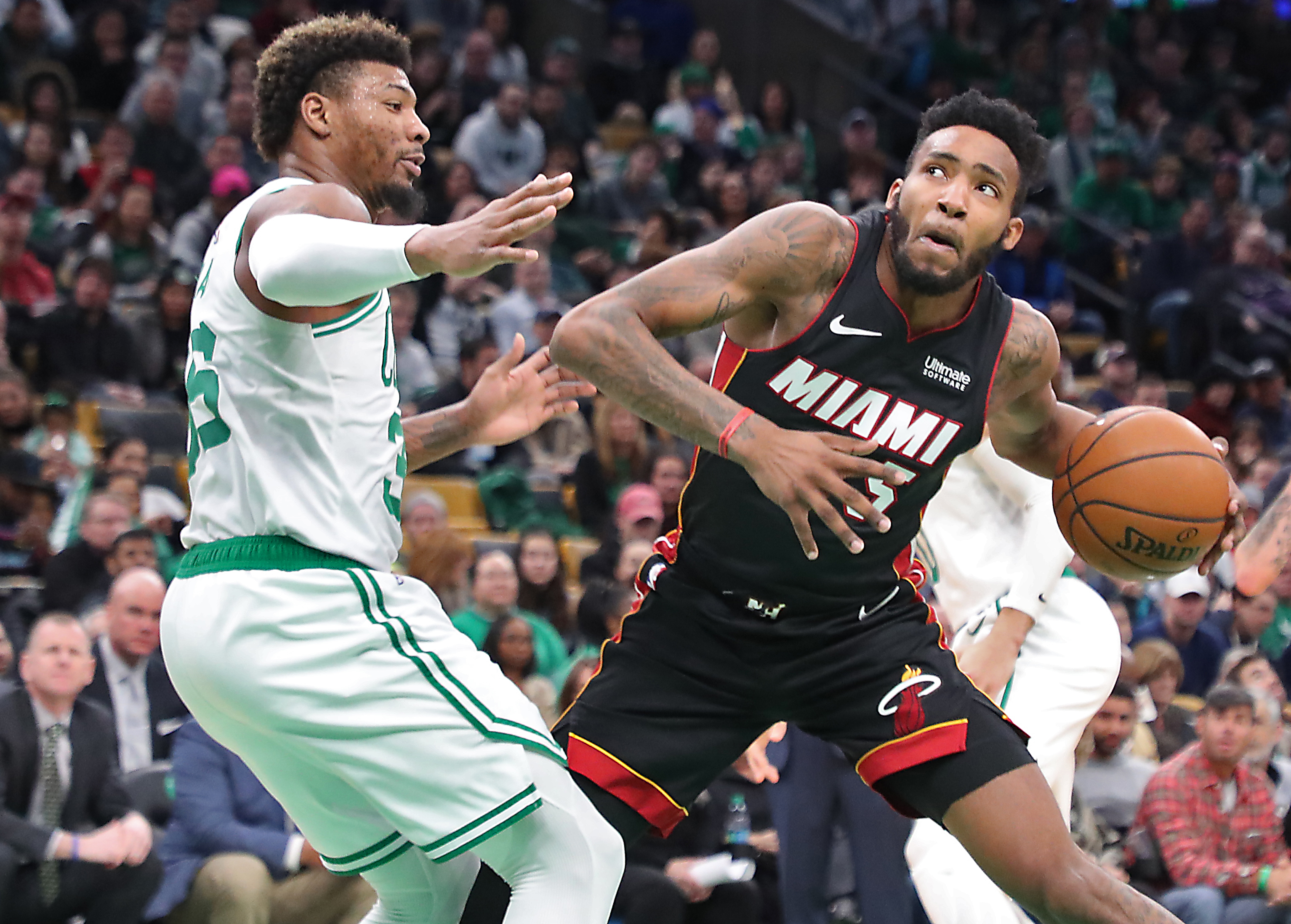 Marcus Smart (left) guards Miami’s Derrick Jones Jr. during the third quarter.