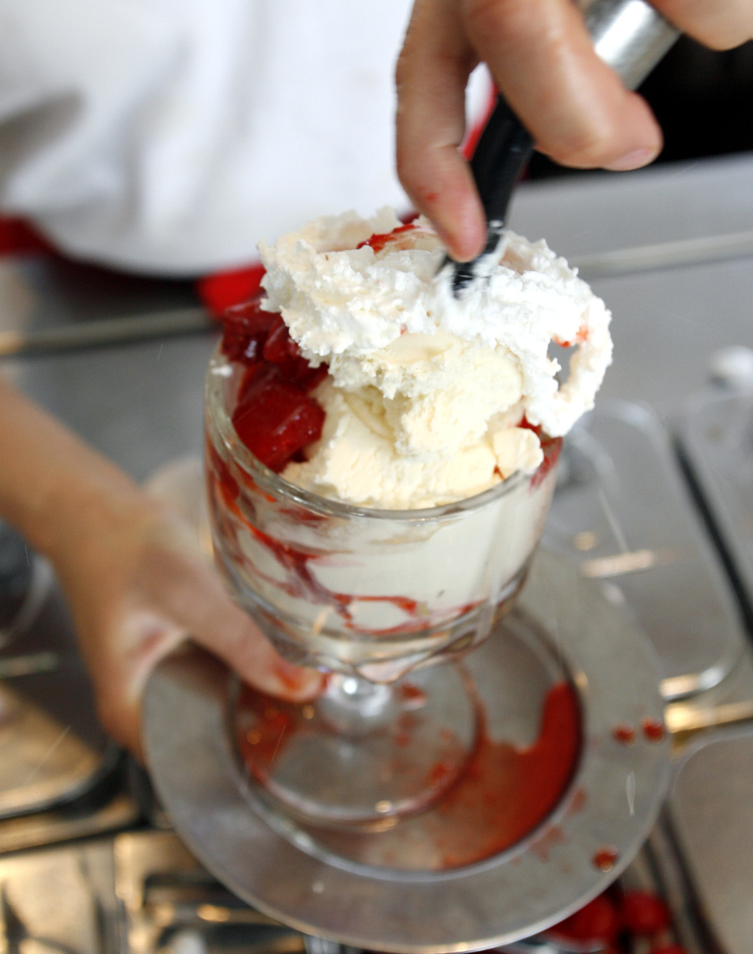 Newton,MA. 5/2/07 A Strawberry Sundae being made at Cabot's Ice Cream in Newton,Ma.on Wednesday May 2,2007. Everything's up to date in the Garden City, but you can still find places in Newton where walking through the door is like stepping out of a time machine.(Bill Polo/Globe Staff) section: wewk; slug:10weoldnewton reporter Ralph Ranalli Library Tag 05172007