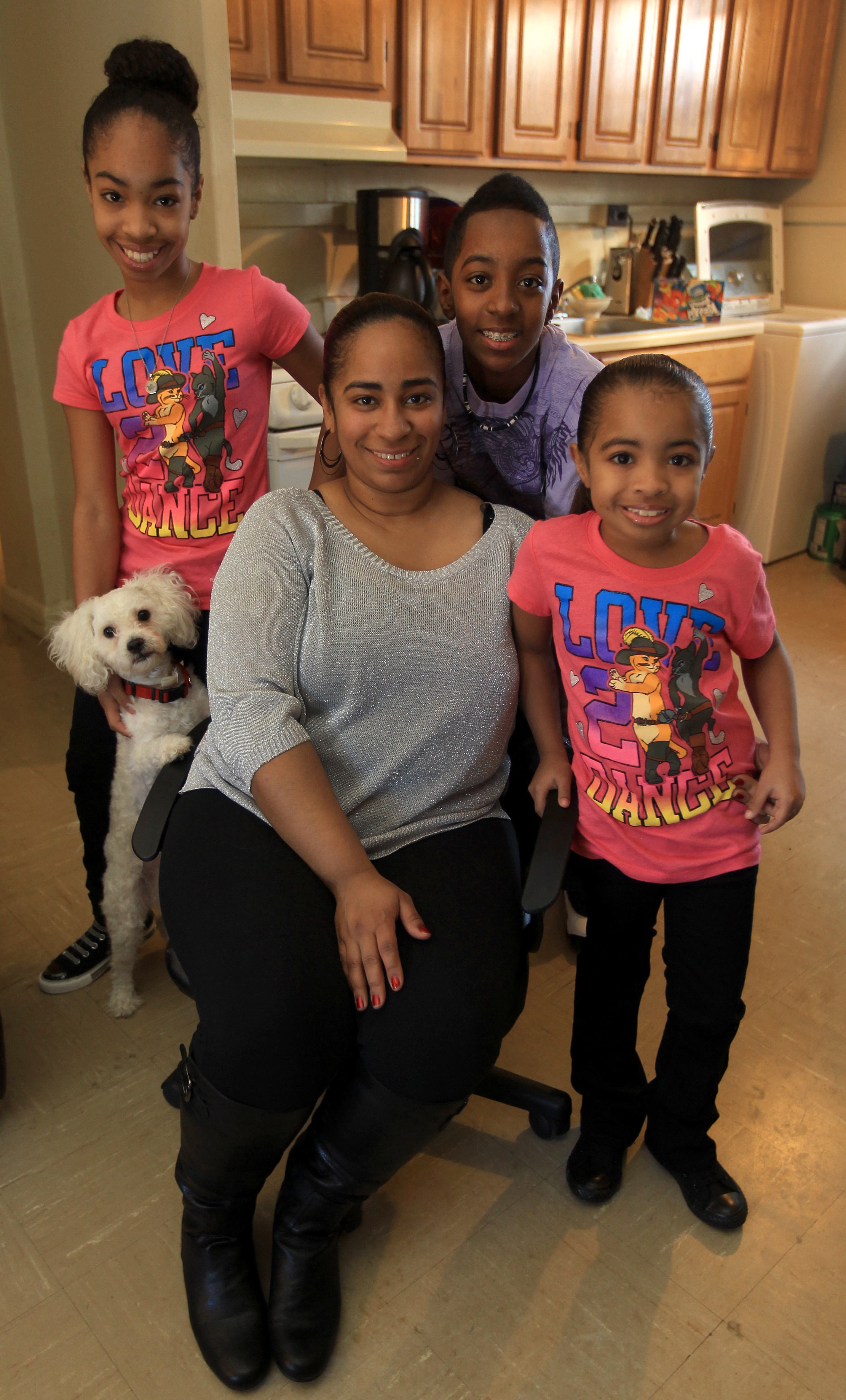 Rebecca Davila and her family live in a housing authority apartment. With her, from left, are Genesis, 11 (with their dog Woody); Luis, 13; and Priscilla, 7. Luis has asthma.