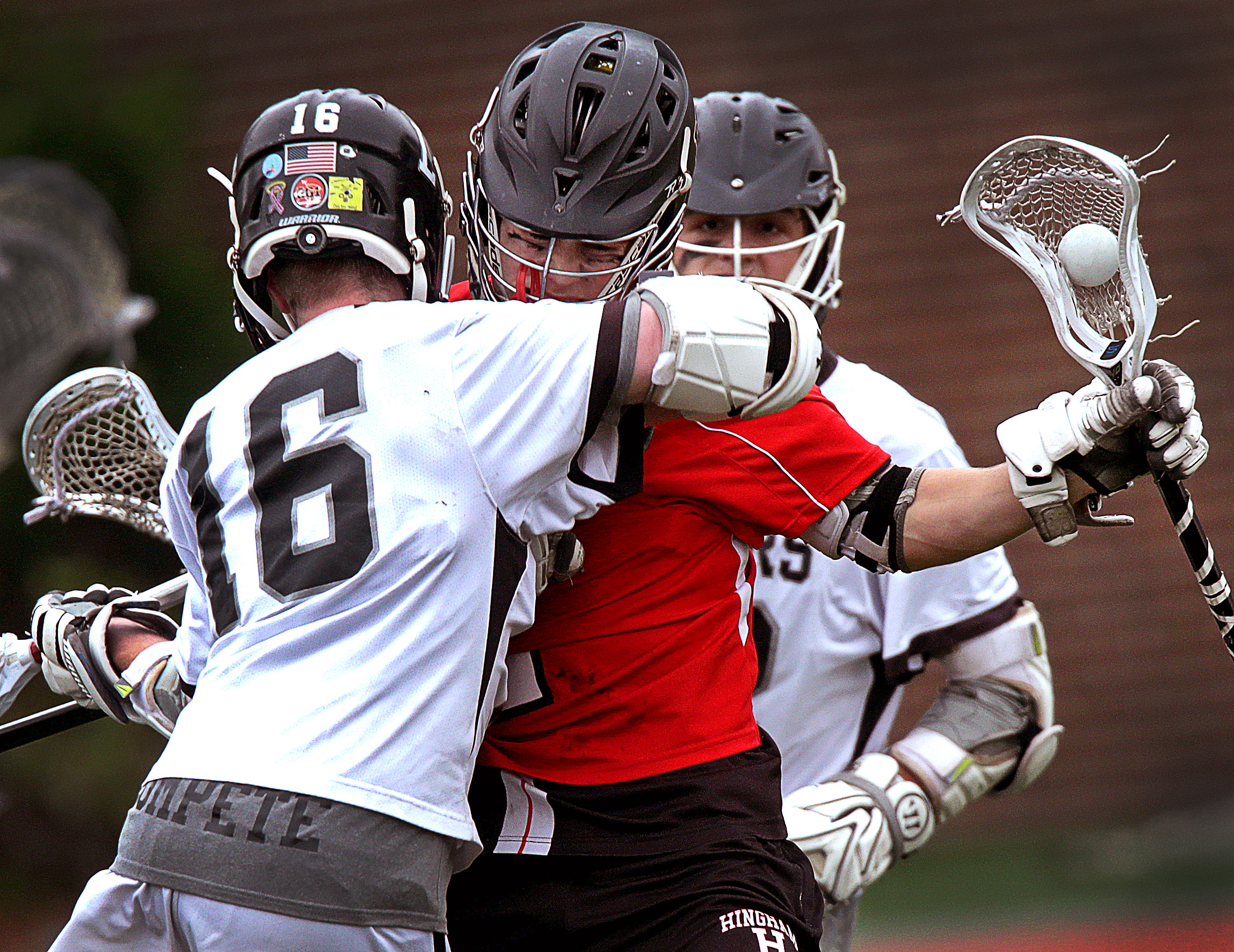 Hingham's Thomas Welch, (2) absorbs a hit from Longmeadow's John Barron, (16), but the Harbormen dealt the crushing blow with their 16-7 victory in the Div. 2 state title game.