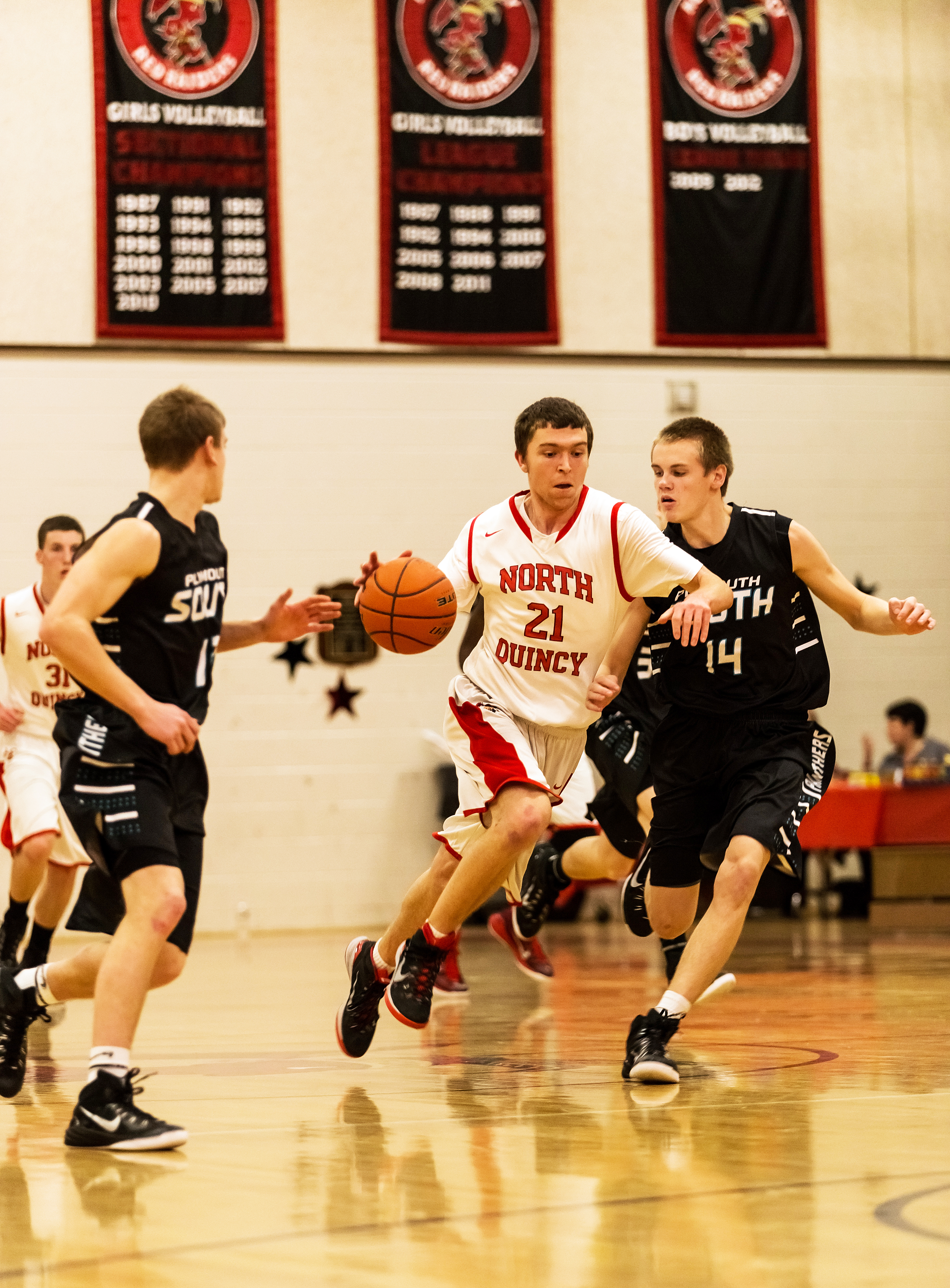 North Quincy High School's Matt Gerakis dribbled between two Plymouth South defenders.