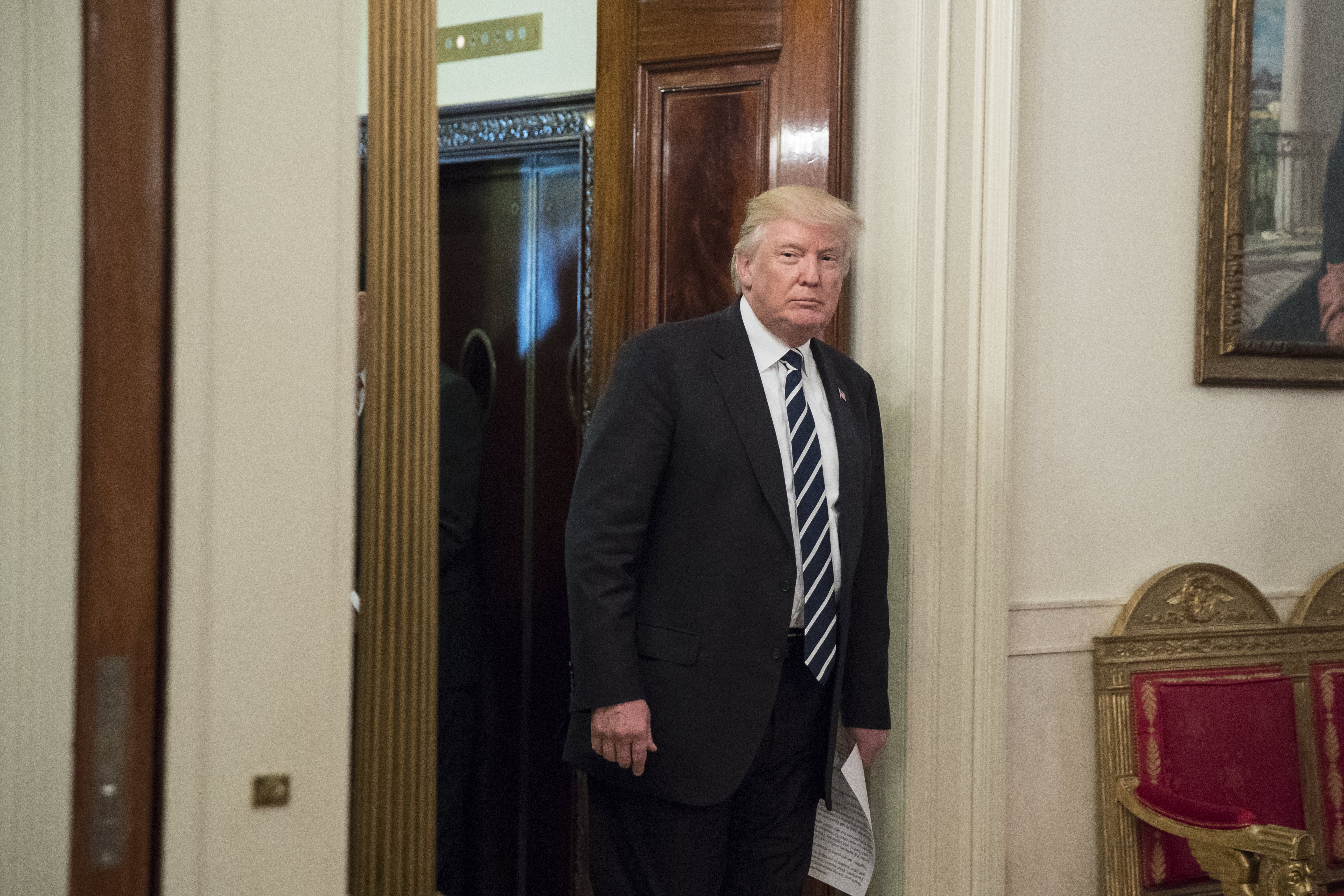 US President Donald J. Trump walked from the Cross Hall into the State Dining Room on Thursday.