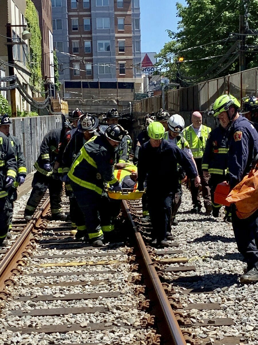 Firefighters and EMT personnel carried the injured out of the tunnel near Kenmore Square after Saturday’s crash.