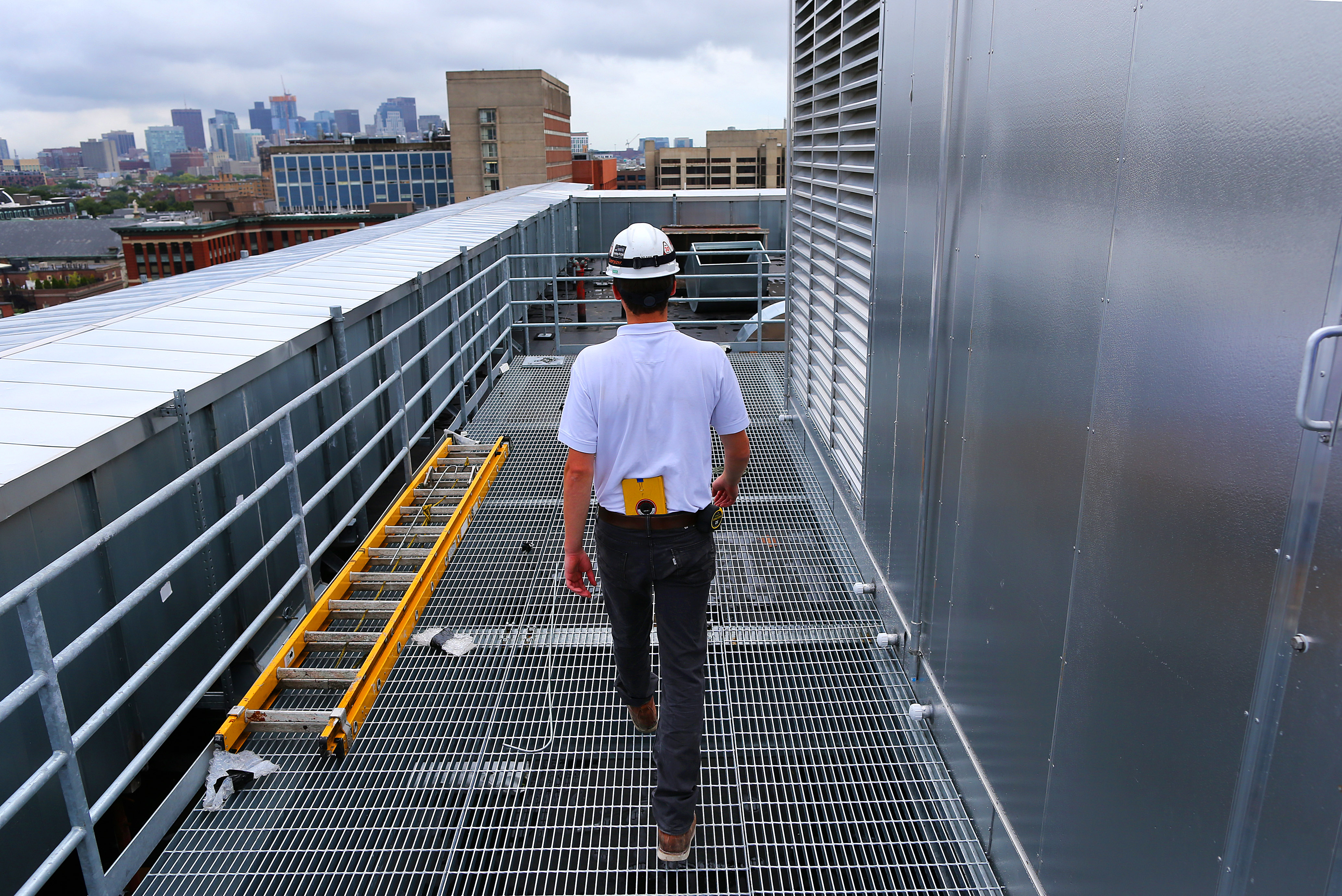 Eric Zeimetz of Shawmut Design and Construction walked next to the new air handling system on the roof of the Yawkey Building.