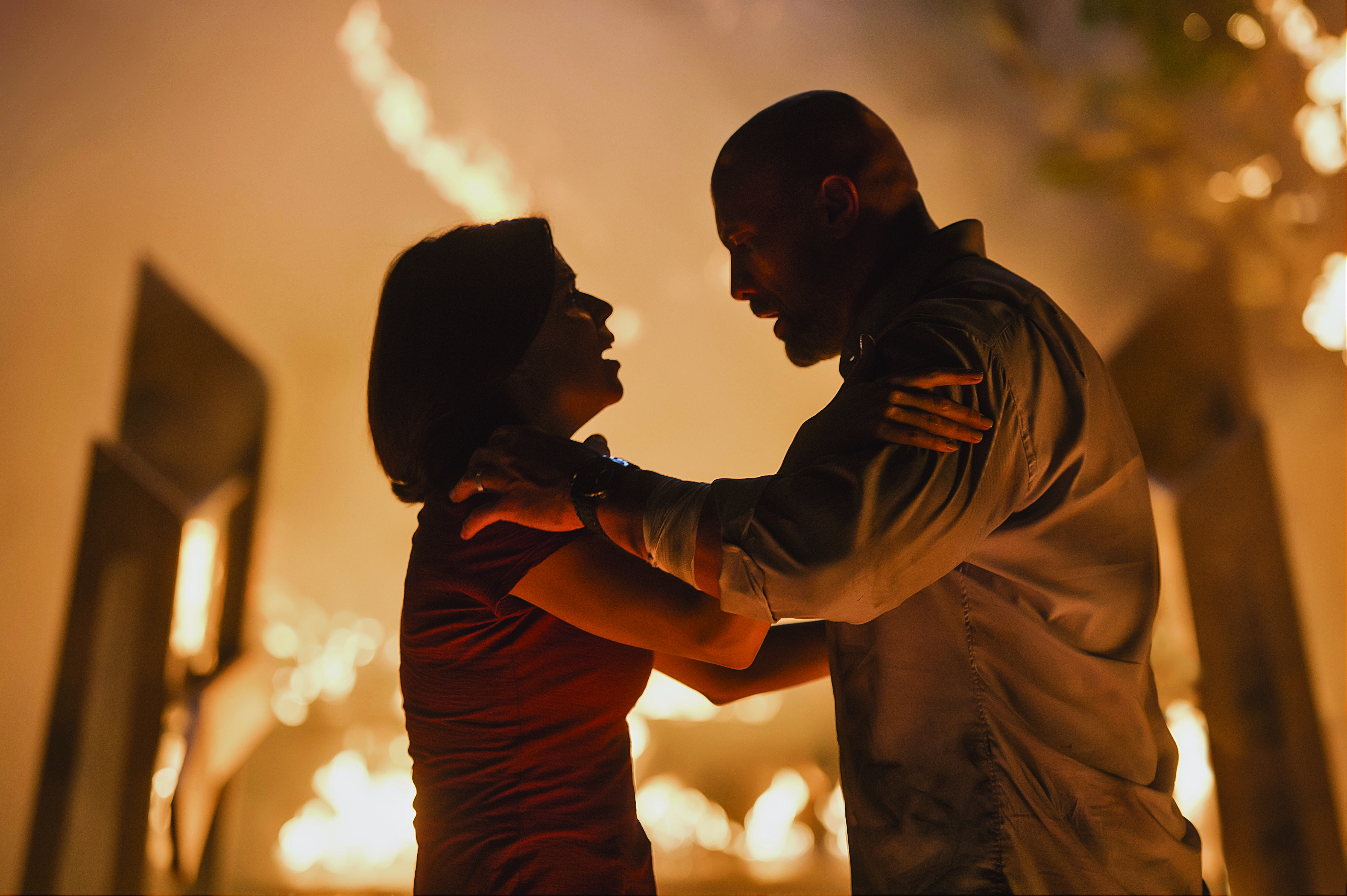 Neve Campbell and Dwayne Johnson in "Skyscraper."