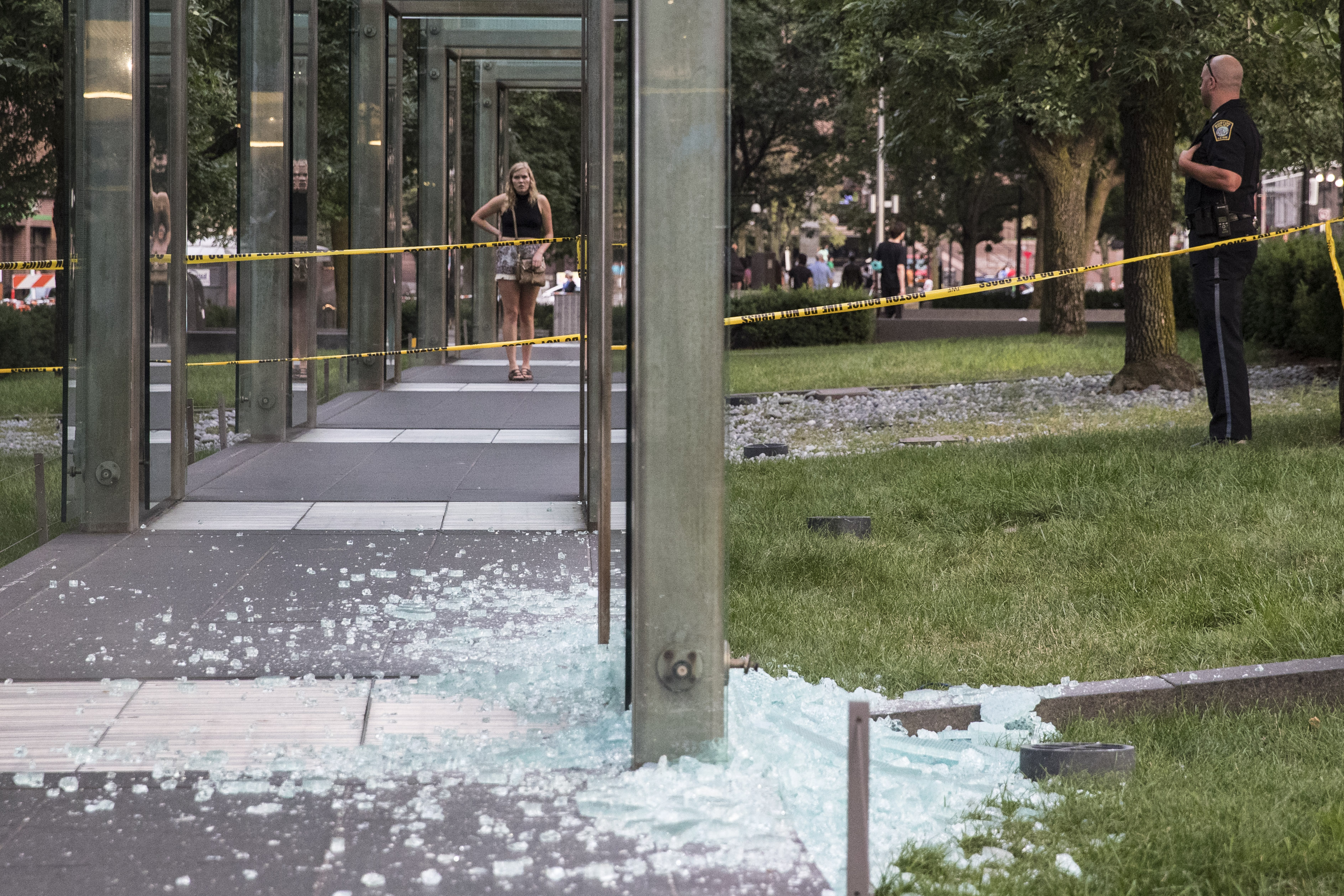 Investigators looked at glass sitting on the ground after it was vandalized.