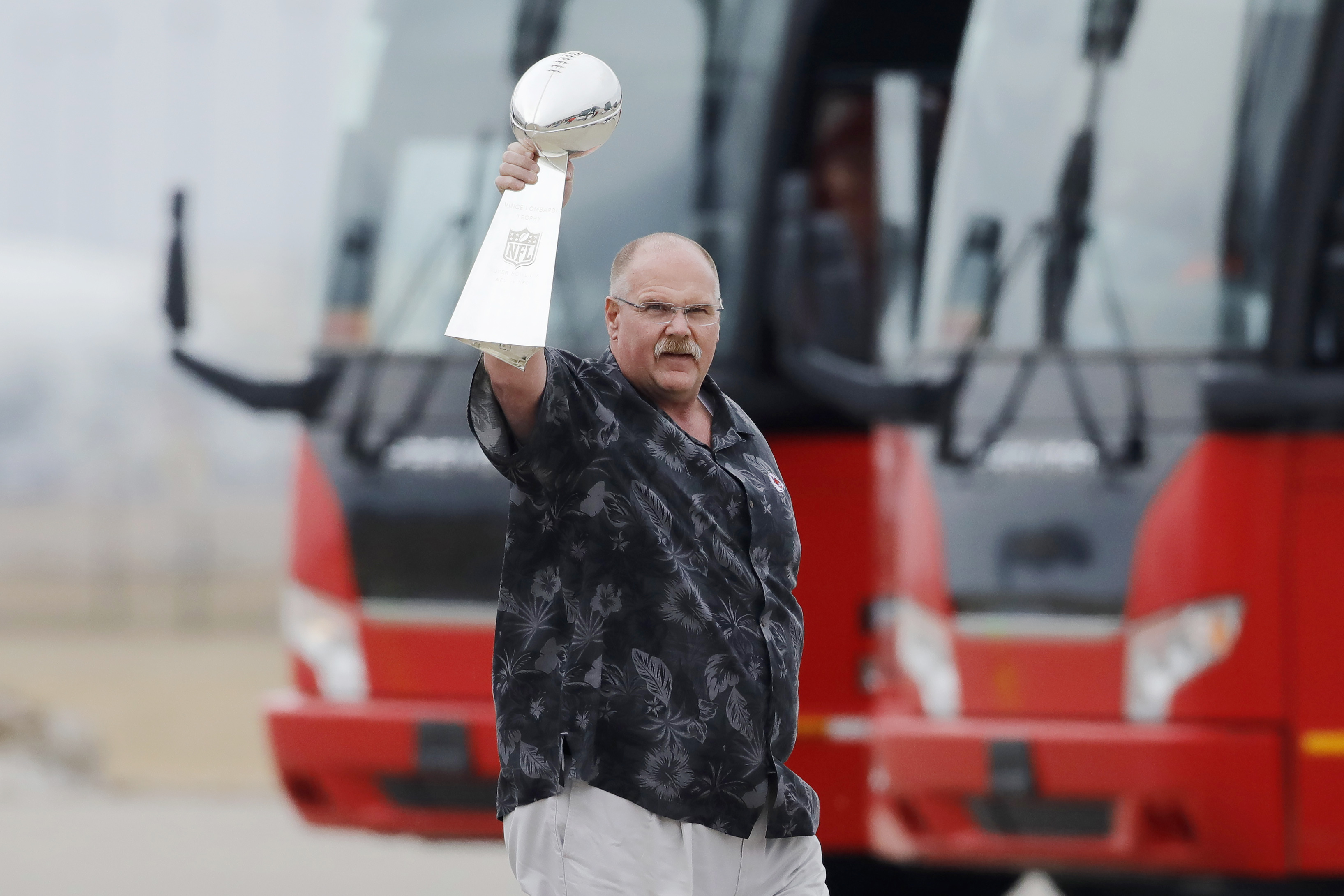 Andy Reid holds up the Vince Lombardi Trophy after the Chiefs landed back in Missouri on Monday.