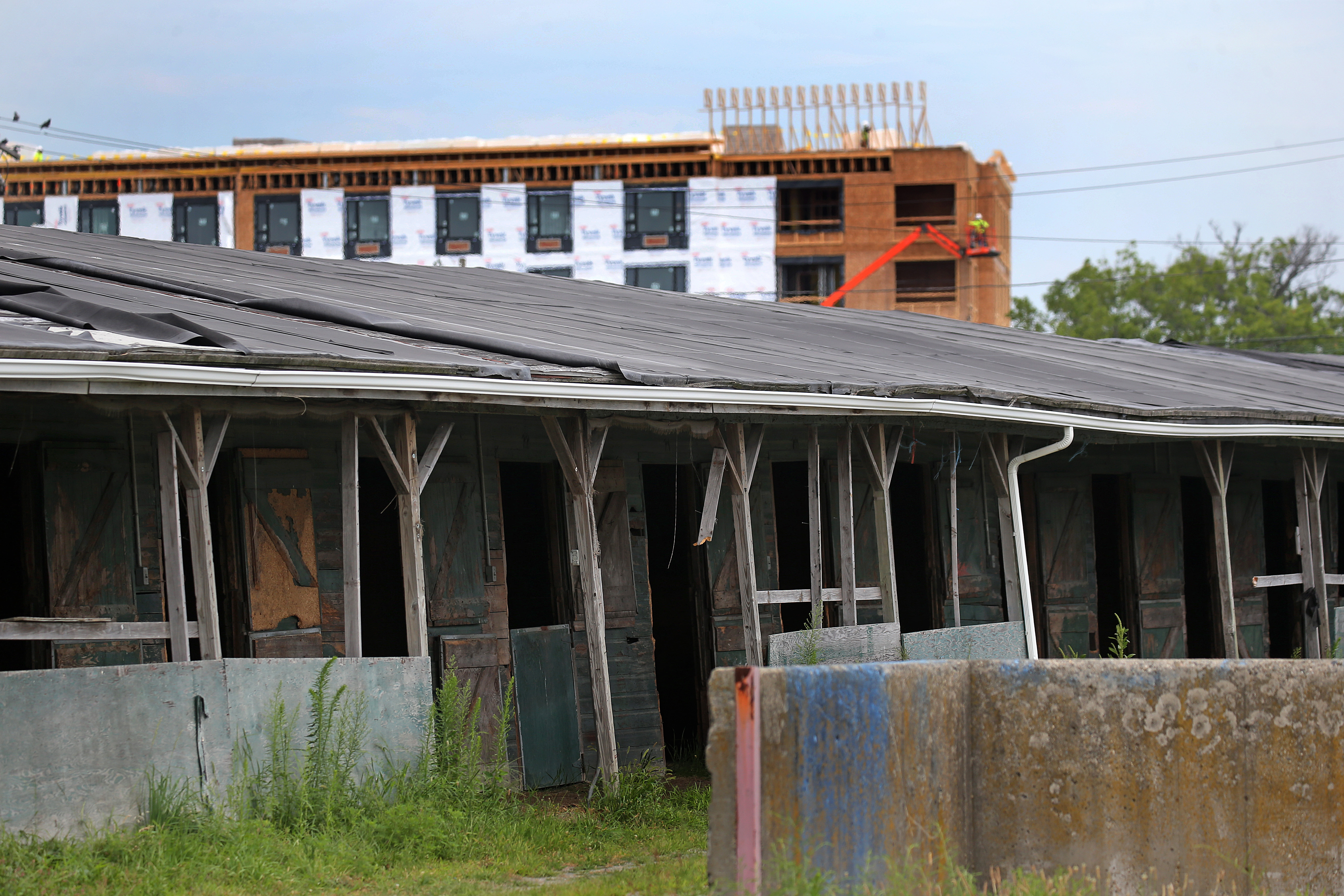 One of many horse barns located at Suffolk Downs, with new construction taking place in the background.