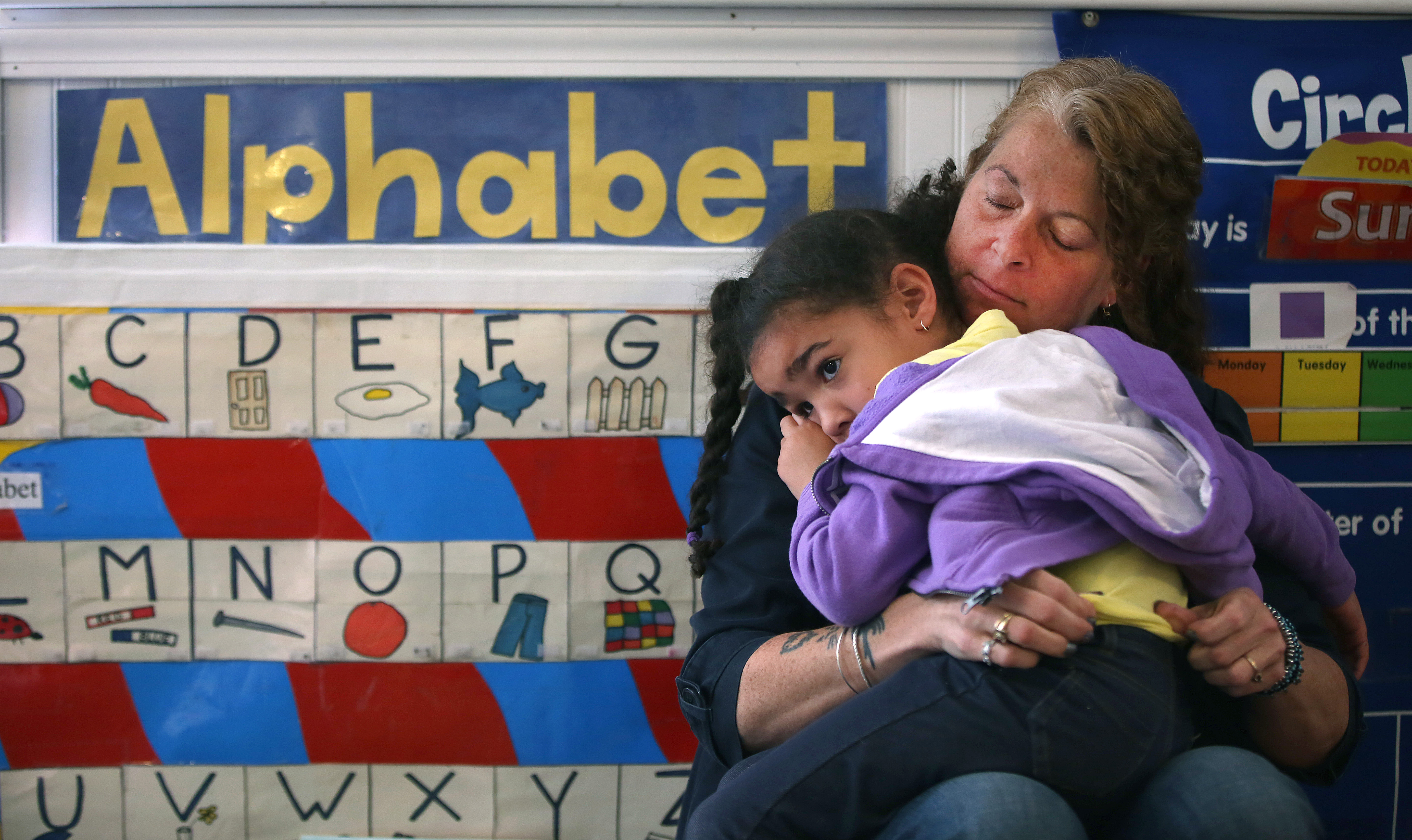 Avery Gormely, 4, needed comforting from teacher Kerrelle Dow at Little Discoveries child care in Brockton in May.