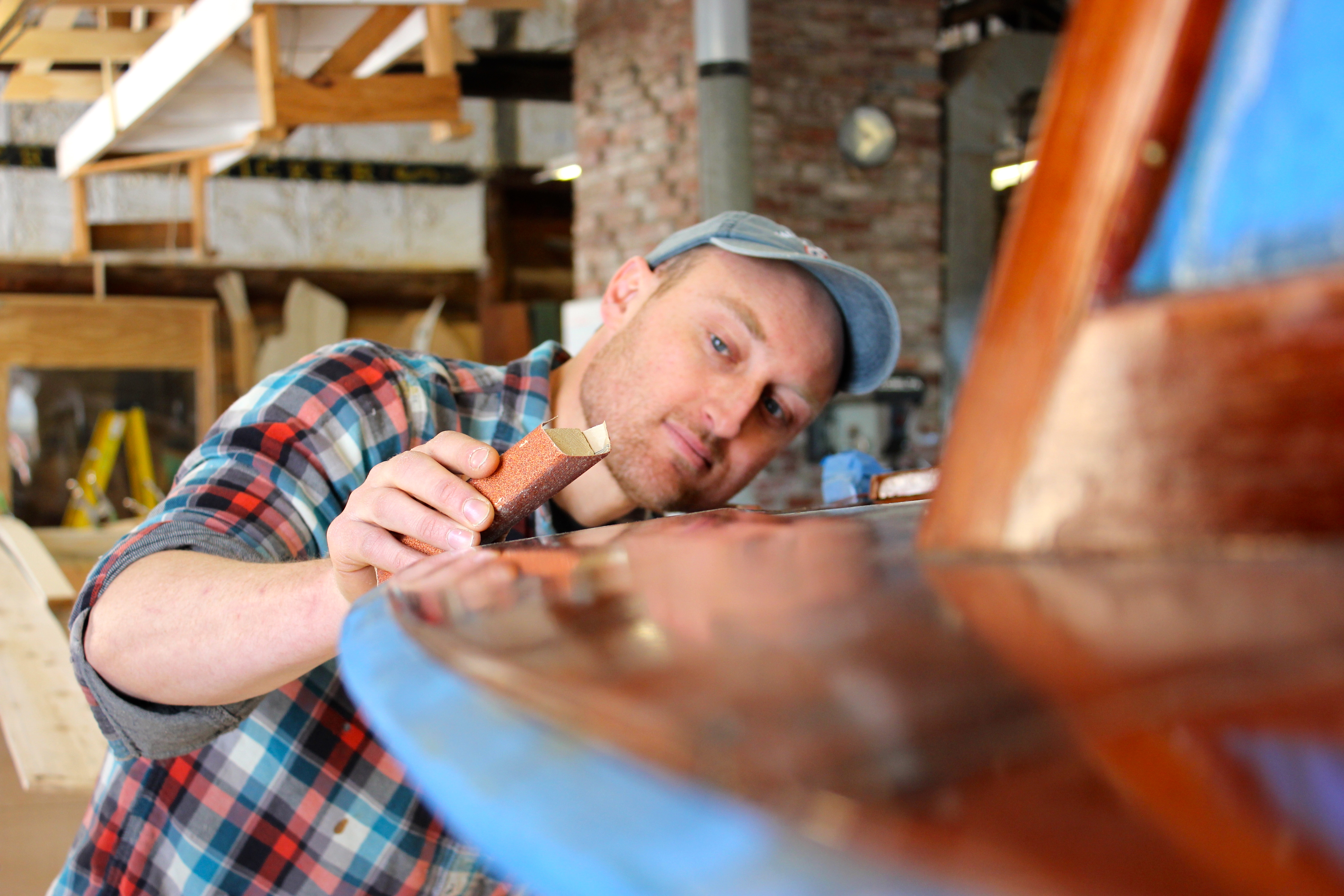 Kurt Spiridakis, Maine Maritime Museum boatshop manager, sanded a boat in the museum's shop.