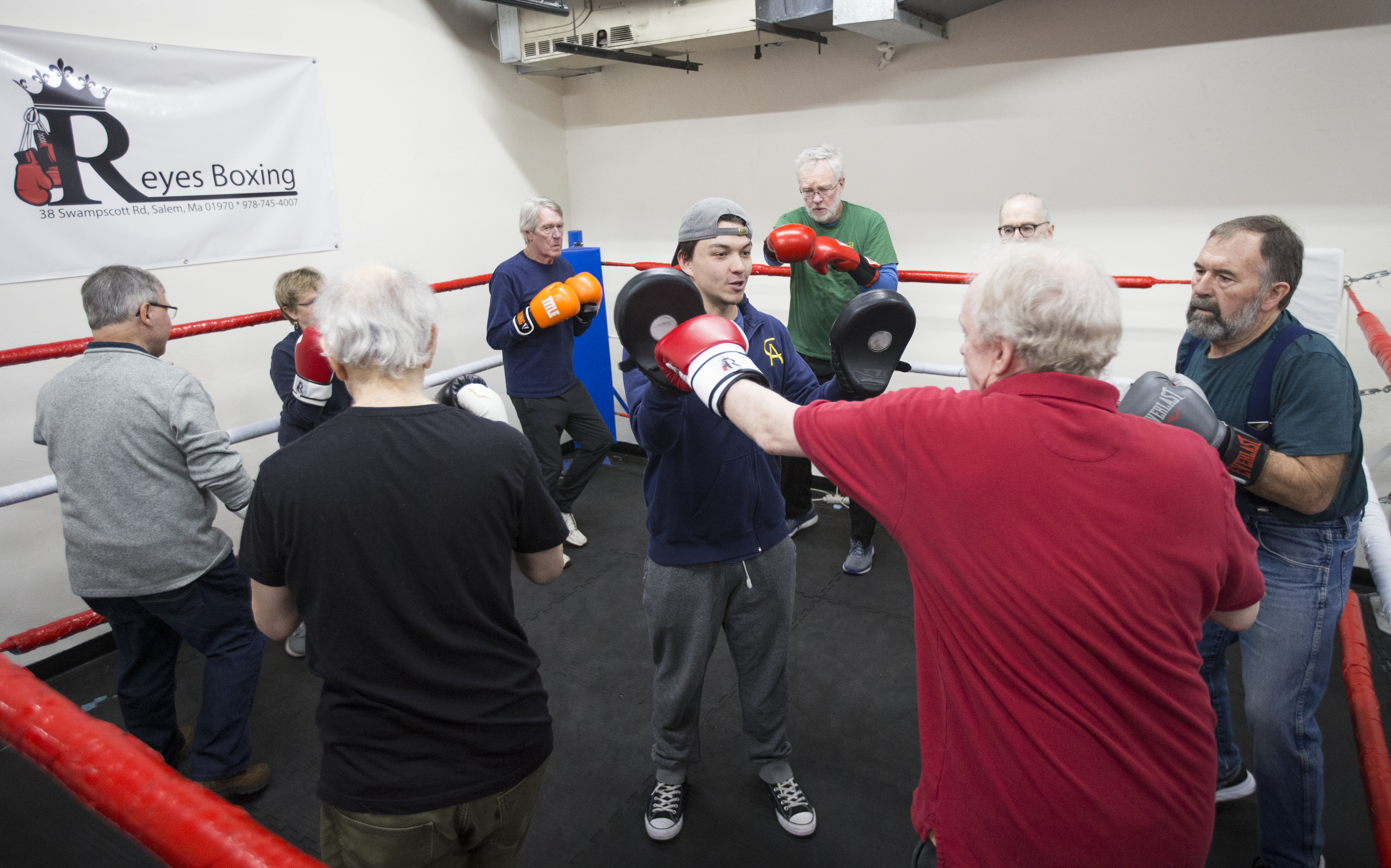 Jake Mulvey (center) takes a group of people through a workout at Salem Fitness Center.