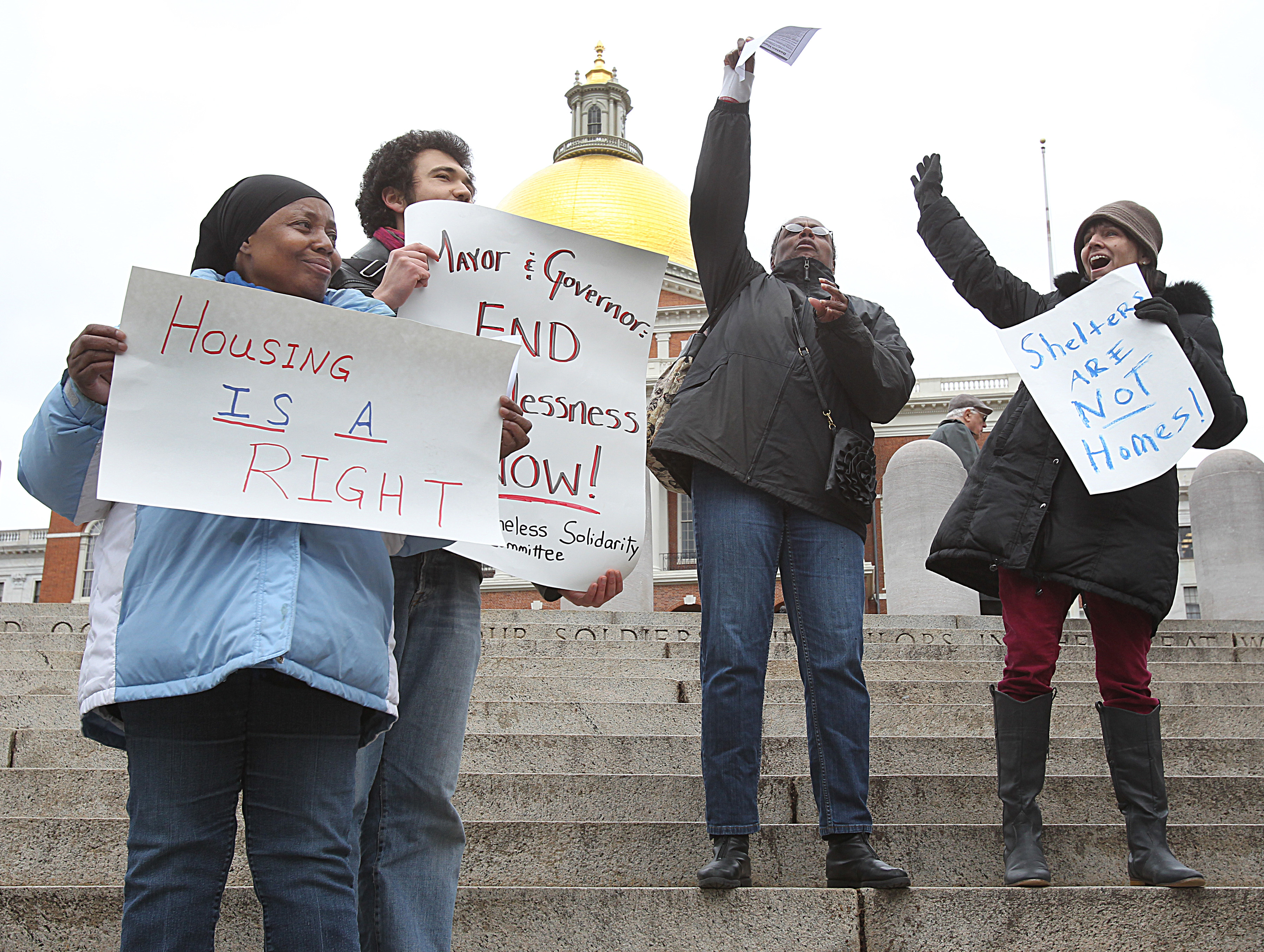 Alise Lewis (left), Lang Haynes, Ronda Jackson, and Karen Kenney were among advocates and former homeless people who demonstrated in front of the State House on Friday.