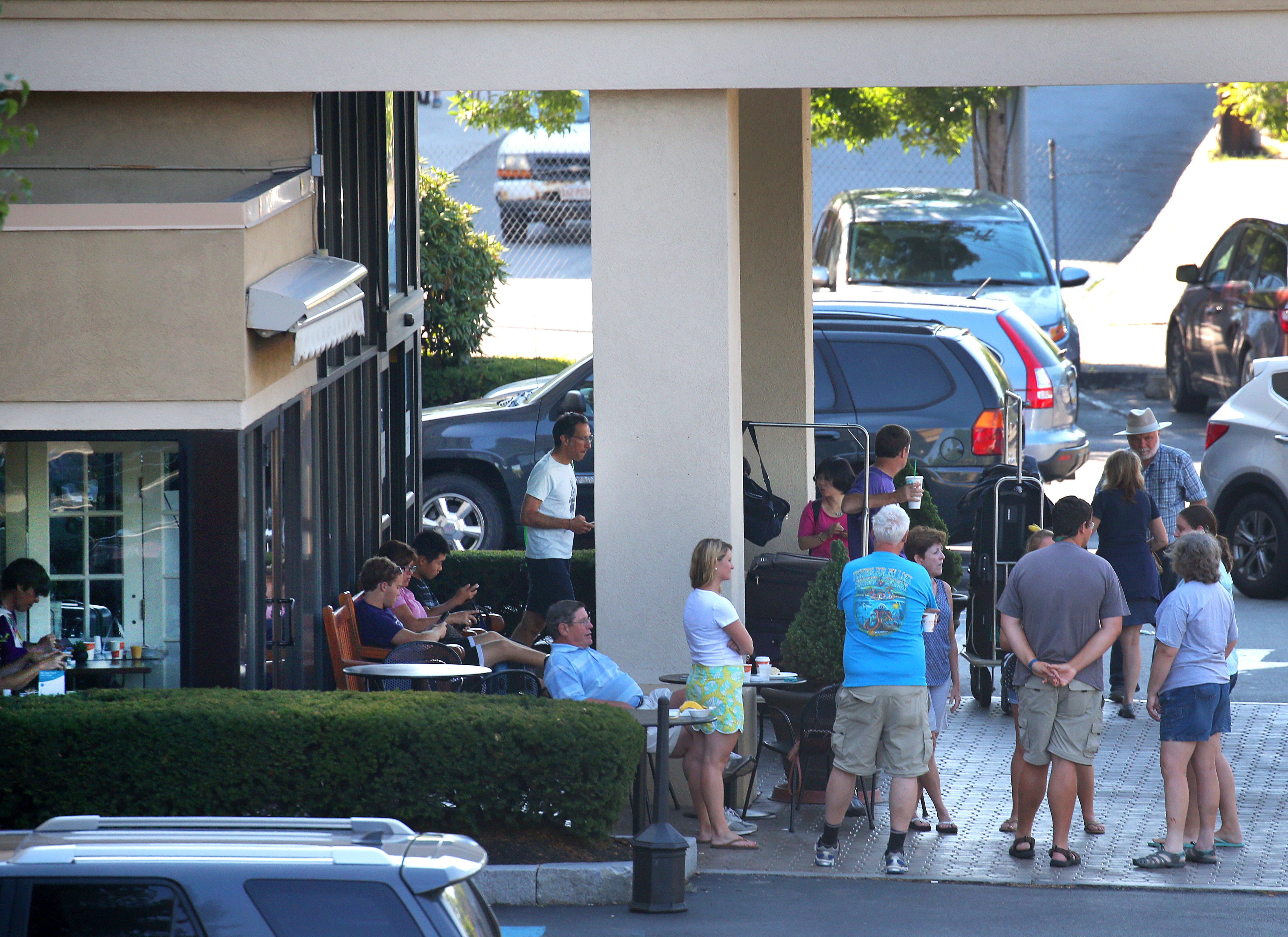 Guests waited under cover for a shuttle in the early morning at the Comfort Inn on Morrissey Boulevard in Dorchester.