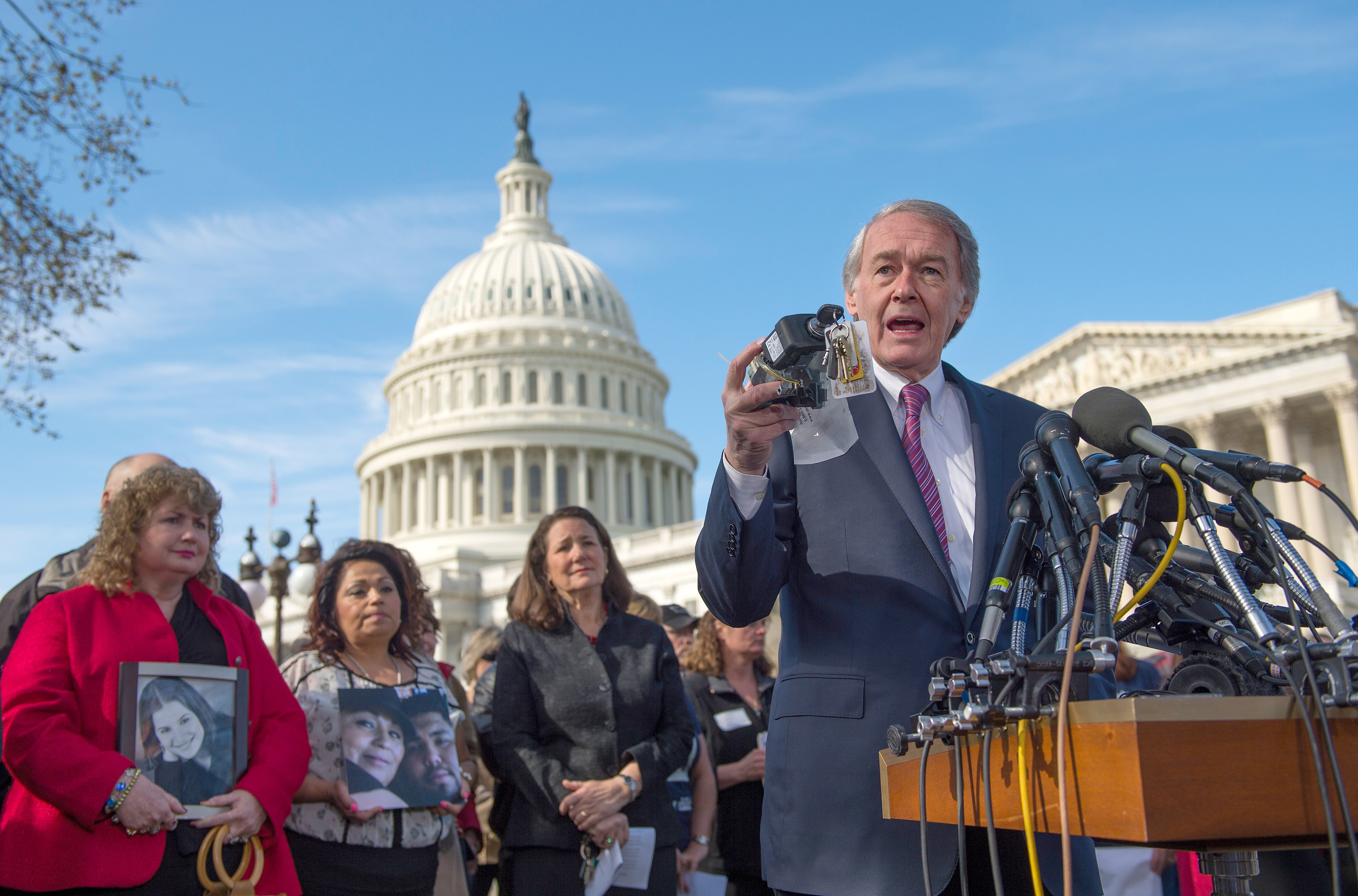 US Senator Edward Markey holds up a faulty GM ignition switch during a 2014 press conference with family members of victims.