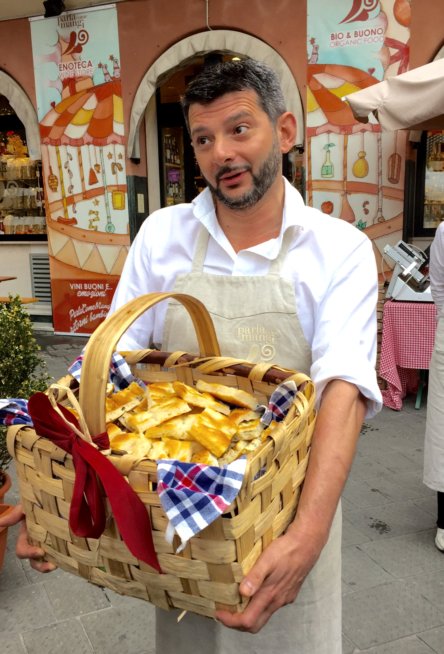 Market owner Guido Porrati offering his focaccia in Rapallo.
