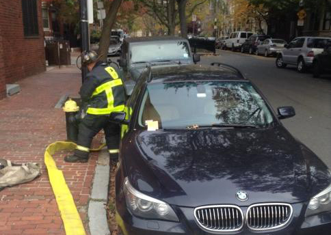 A car parked in front of a hydrant near the South End fire.