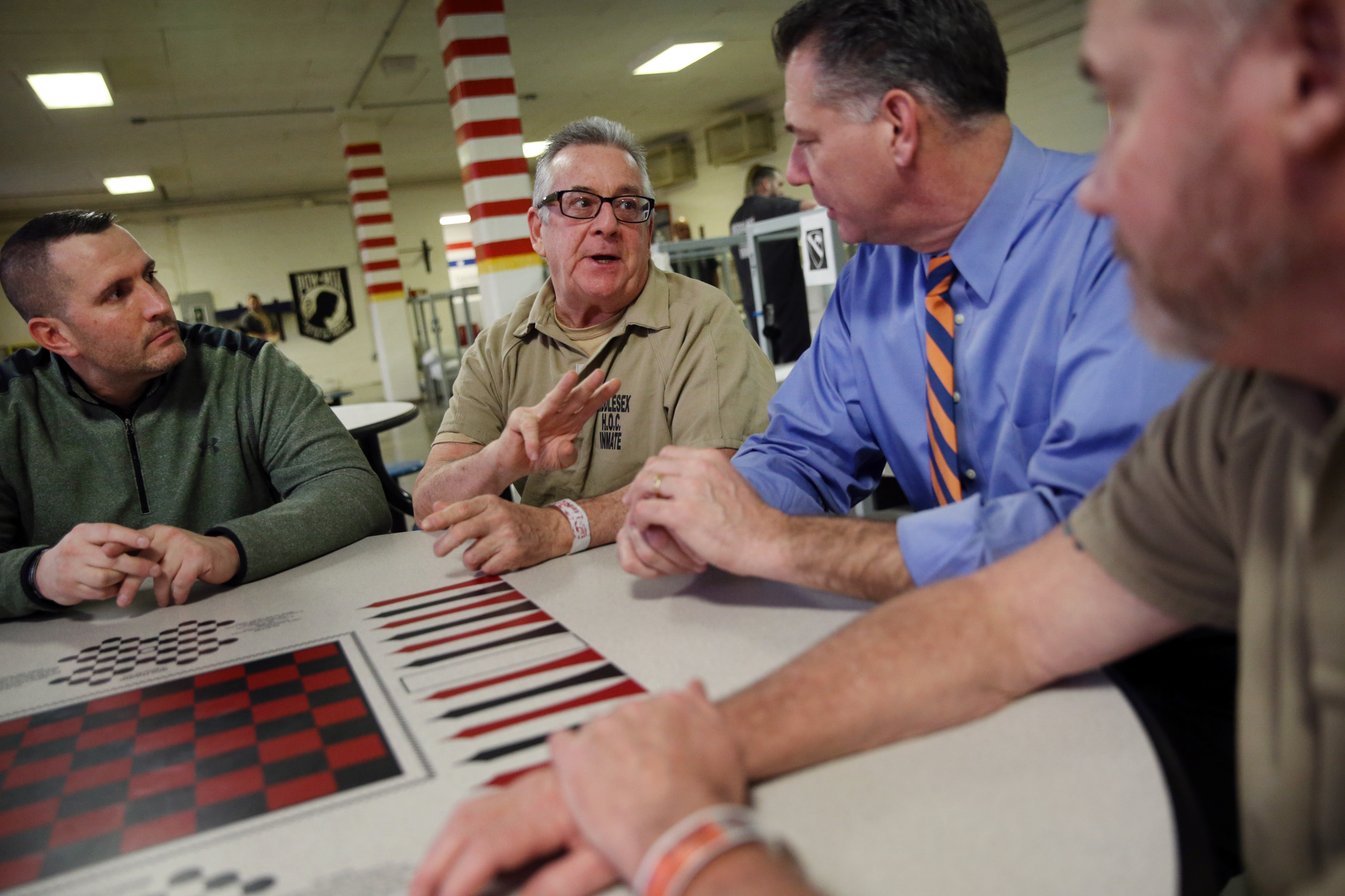 From left: Connor, inmate Bill Matthews, Koutoujian, and Faherty talked in the Housing Unit for Military Veterans.