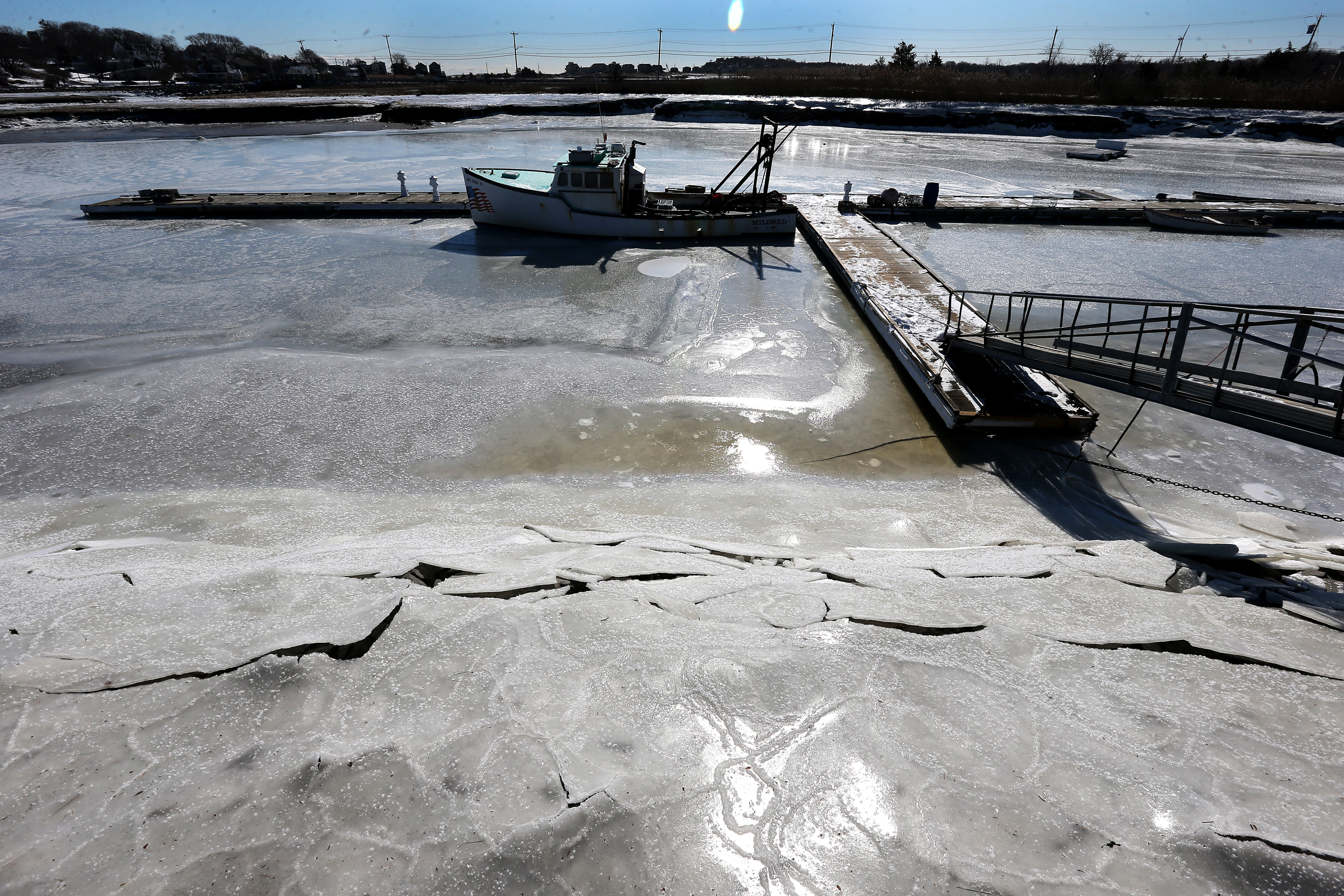 The fishing boat Mildred was frozen to the dock in Scituate Harbor early Sunday morning as the temperature on the coast was minus 2 degrees.