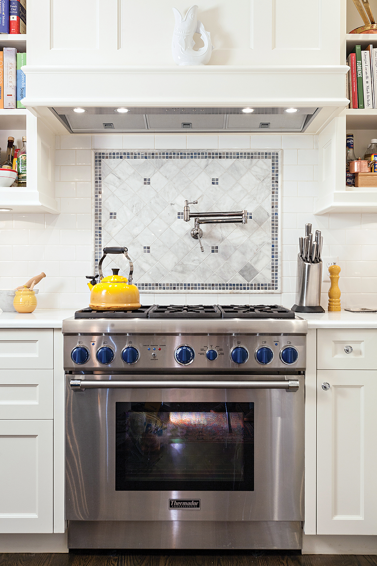 Above the Thermador range, a Rohl pot filler helps with pasta prep.