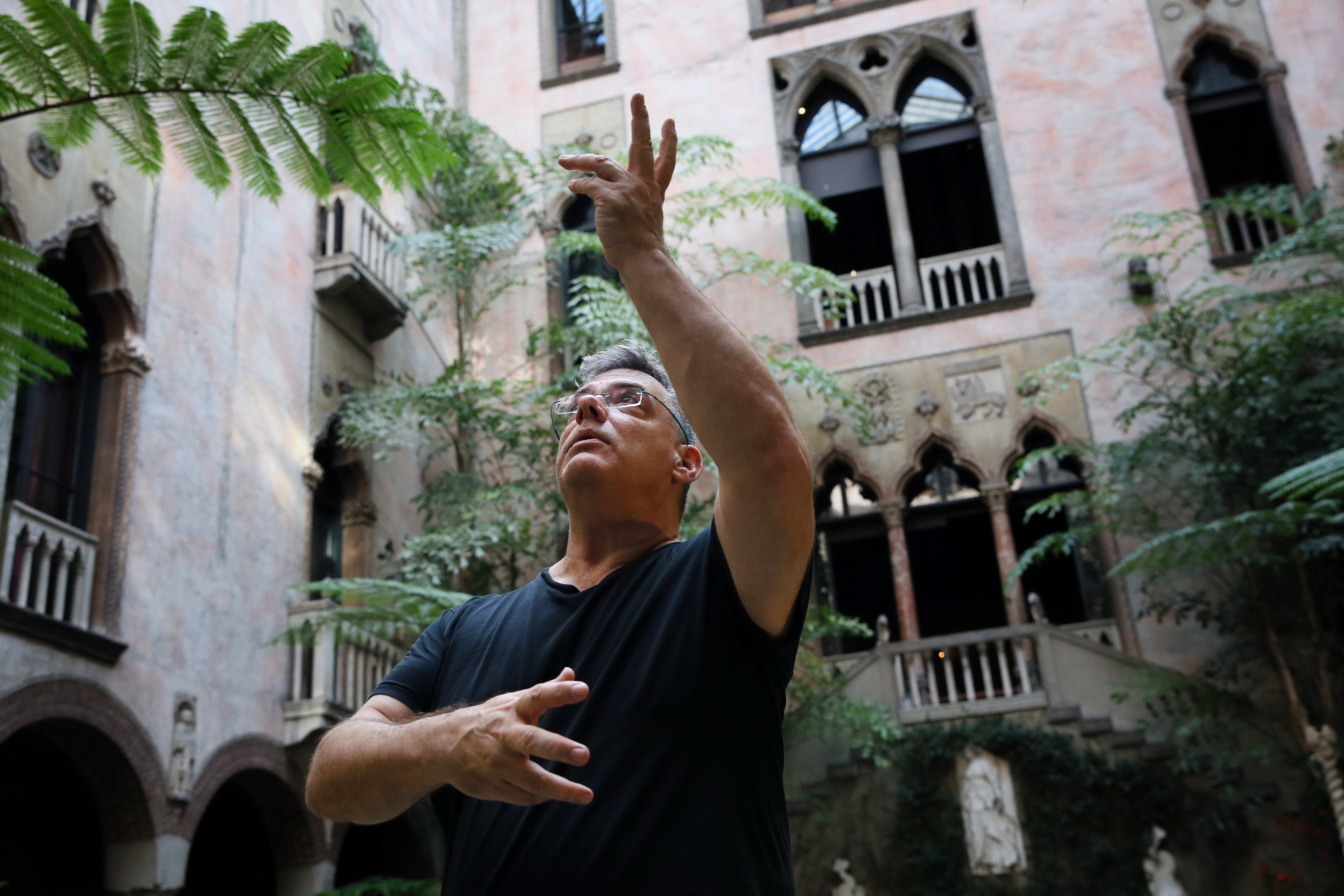 Choreographer Peter DiMuro, in the Gardner Museum’s courtyard, directs the dancers.