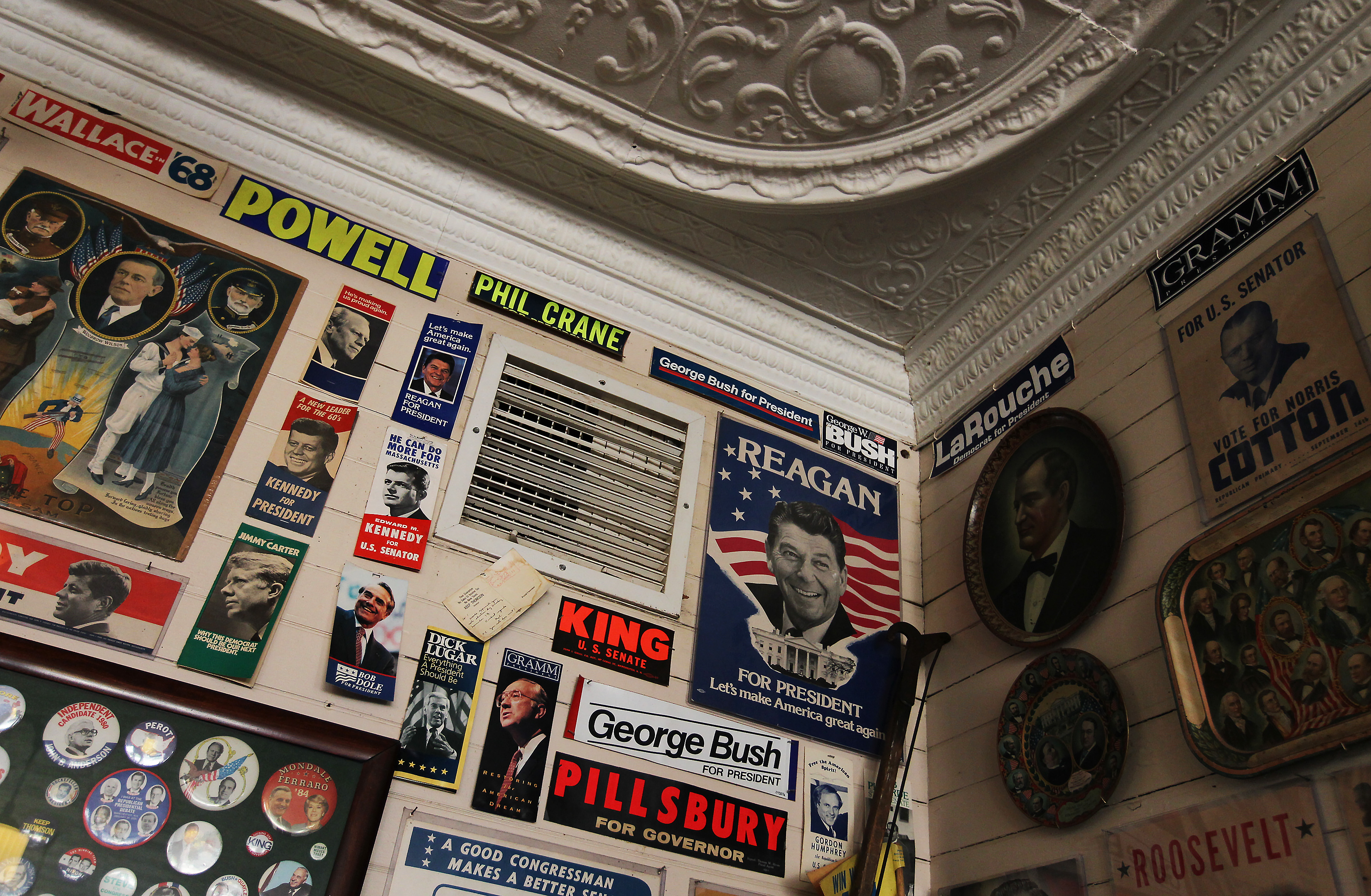 A tin ceiling frames years of political posters and bumper stickers on the walls of Robie's Country Store.
