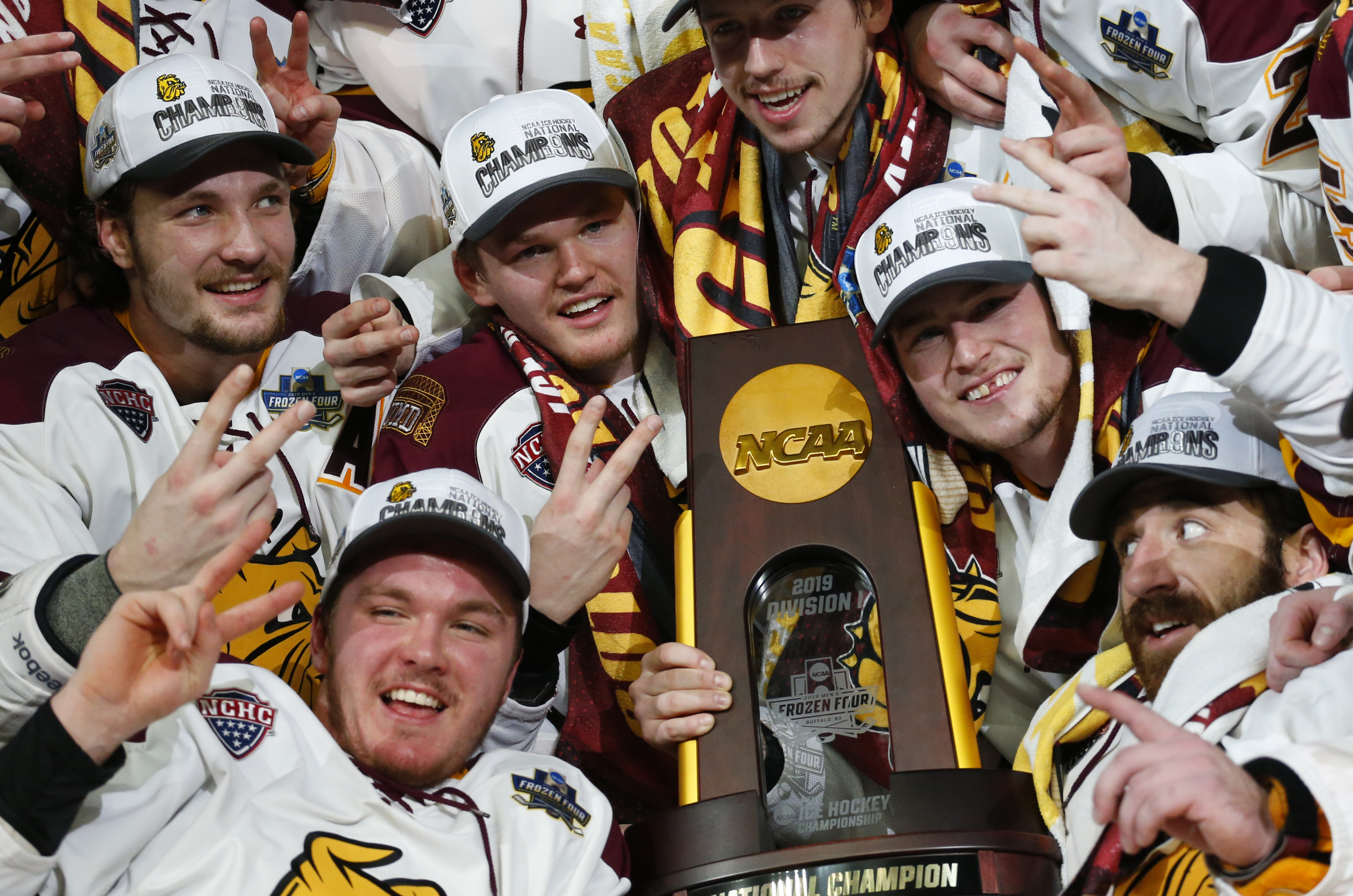 Minnesota Duluth players celebrate a 3-0 victory over UMass for the title.