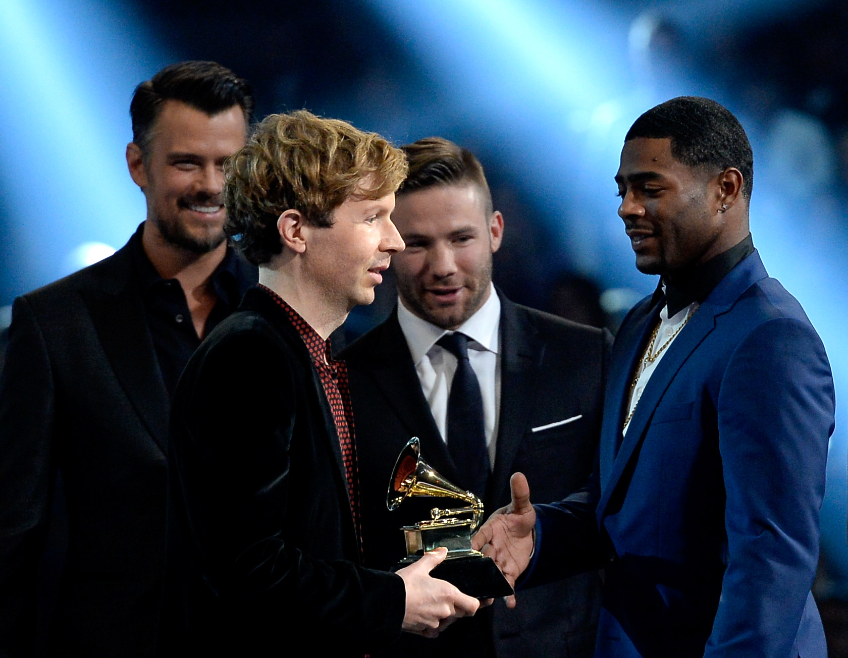 Beck (second from left) accepted Album of the Year and congratulations from Malcolm Butler (left) and Julian Edelman (second from left.)