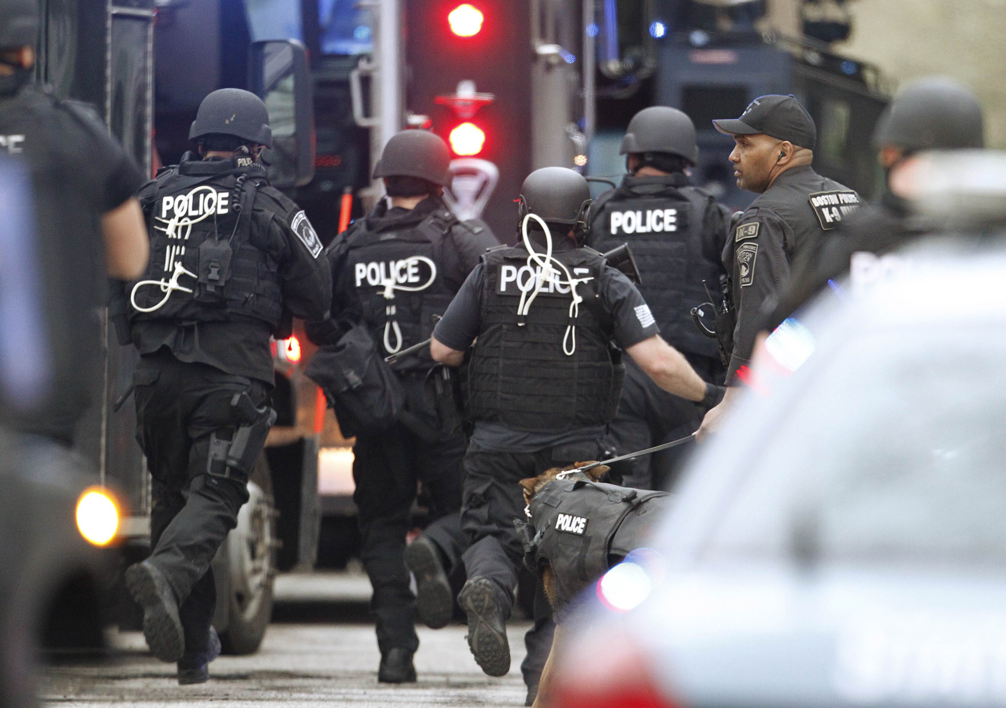 SWAT officers ran toward a house on Franklin Street in Watertown during the search for Dzhokhar Tsarnaev on April 19, 2013.